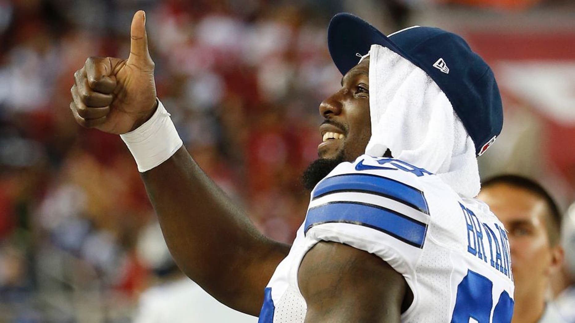 Dallas Cowboys wide receiver Dez Bryant gestures to fans during the second half of an NFL preseason football game against the San Francisco 49ers in Santa Clara, Calif., Sunday, Aug. 23, 2015. (AP Photo/Tony Avelar)