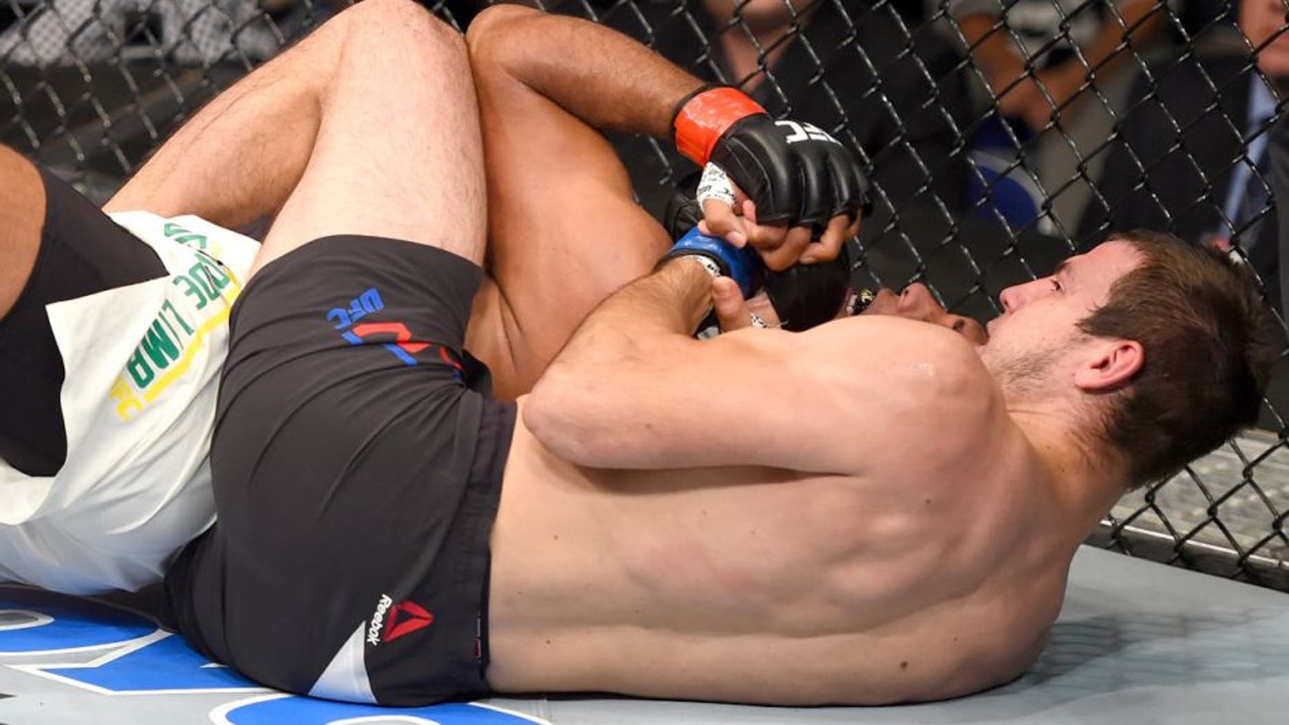 SASKATOON, SK - AUGUST 23: (R-L) Nikita Krylov of Ukraine secures a rear choke submission against Marcos Rogerio de Lima of Brazil in their light heavyweight bout during the UFC event at the SaskTel Centre on August 23, 2015 in Saskatoon, Saskatchewan, Canada. (Photo by Jeff Bottari/Zuffa LLC/Zuffa LLC via Getty Images)