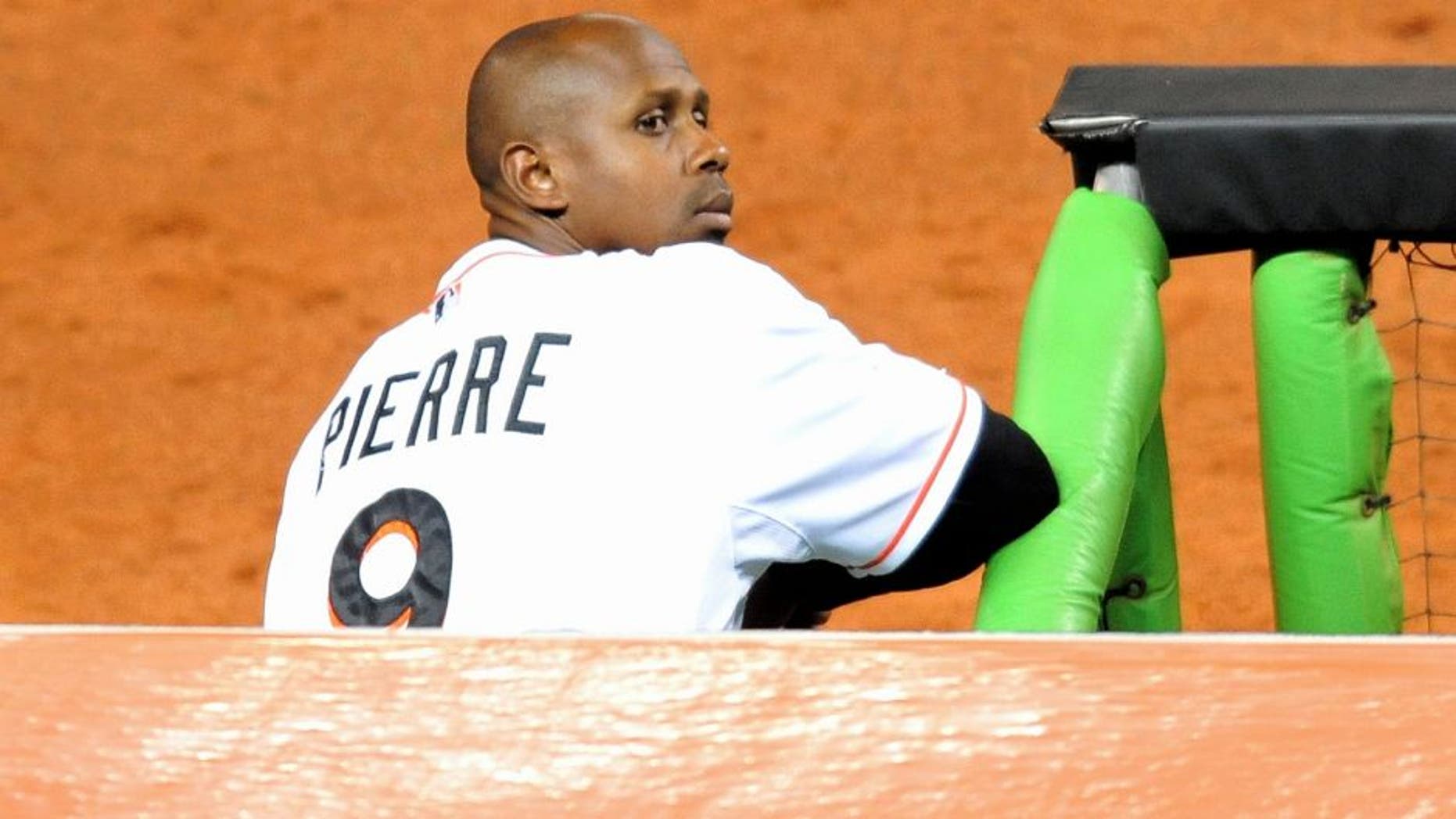 Sep 9, 2013; Miami, FL, USA; Miami Marlins left fielder Juan Pierre (9) looks on from the dugout during the third inning against the Atlanta Braves at Marlins Park. Mandatory Credit: Steve Mitchell-USA TODAY Sports