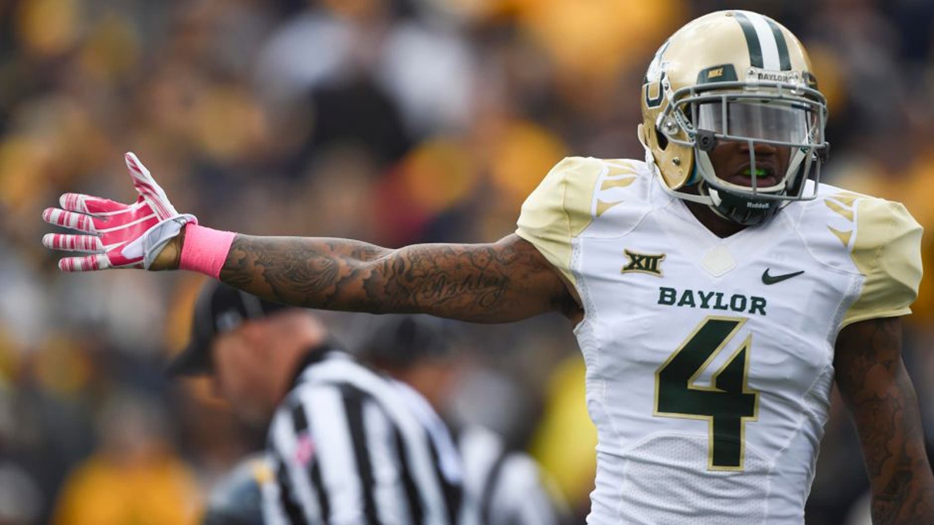 Oct 18, 2014; Morgantown, WV, USA; Baylor Bears cornerback Xavien Howard (4) signals they had recovered the fumble during the first quarter against the West Virginia Mountaineers at Milan Puskar Stadium. Mandatory Credit: Tommy Gilligan-USA TODAY Sports