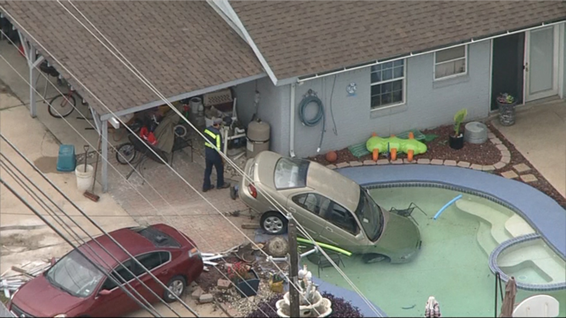 Police respond after a car crashed into a pool in Arlington, Texas Wednesday.