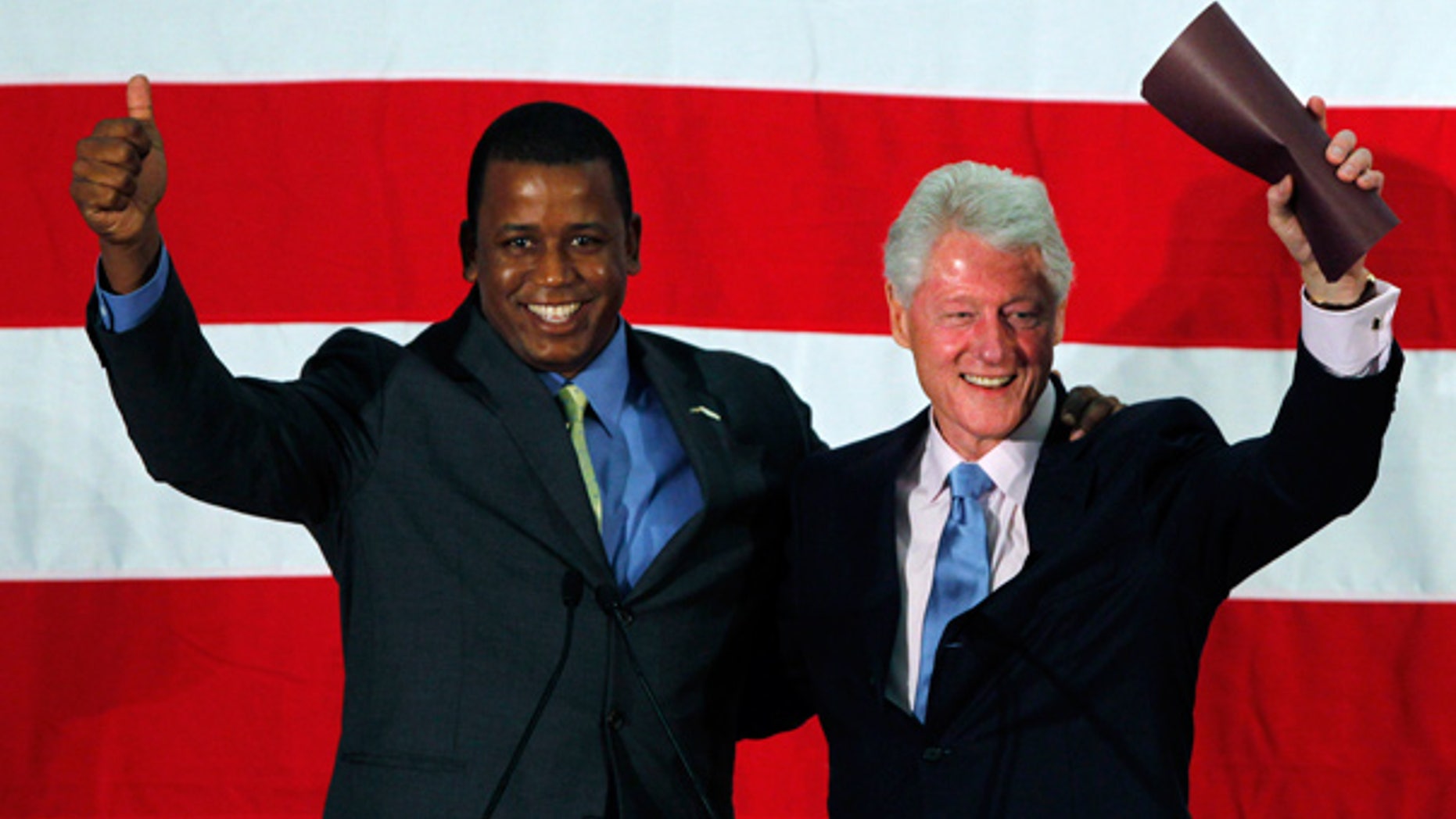 Aug. 16: Rep. Kendrick Meek and Former President Bill Clinton wave as they are introduced during a rally in Davie, Fla.