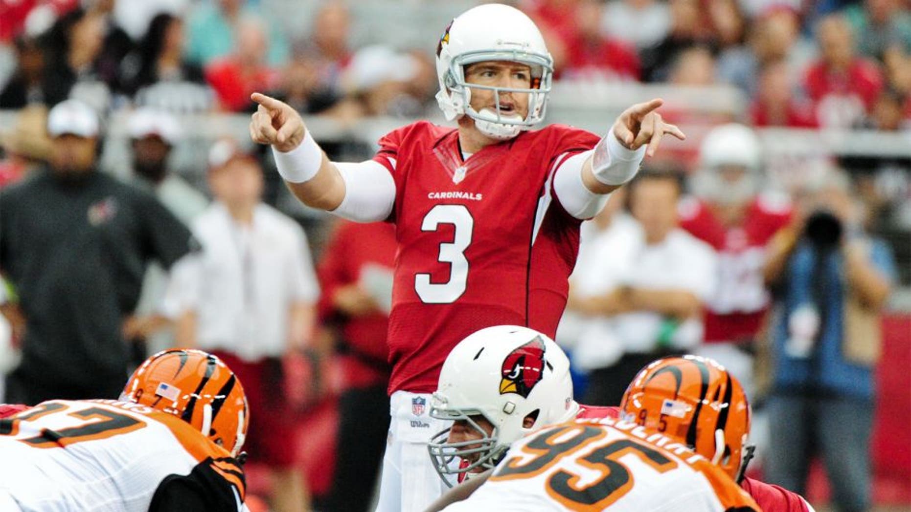 Aug 24, 2014; Glendale, AZ, USA; Arizona Cardinals quarterback Carson Palmer (3) signals to teammates prior to the snap during the first half against the Cincinnati Bengals at University of Phoenix Stadium. Mandatory Credit: Matt Kartozian-USA TODAY Sports