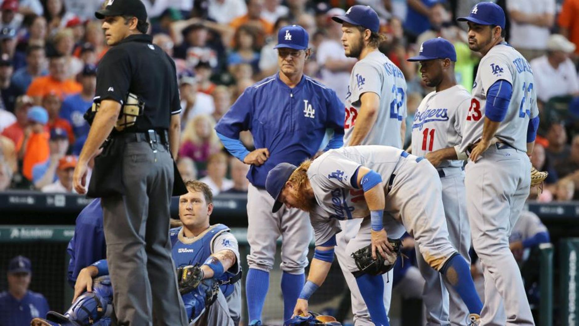 HOUSTON, TX - AUGUST 23: Catcher A.J. Ellis #17 of the Los Angeles Dodgers sits on the ground after a tough slide by Carlos Gomez #30 of the Houston Astros in the sixth inning during their game at Minute Maid Park on August 23, 2015 in Houston, Texas. (Photo by Scott Halleran/Getty Images)