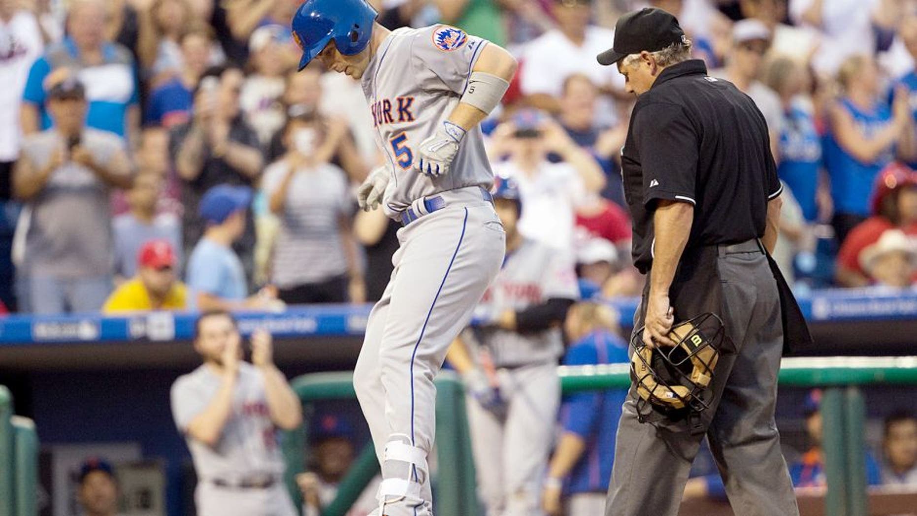 Aug 24, 2015; Philadelphia, PA, USA; New York Mets third baseman David Wright (5) jumps on home plate after hitting a solo home run during the second inning against the Philadelphia Phillies at Citizens Bank Park. Mandatory Credit: Bill Streicher-USA TODAY Sports