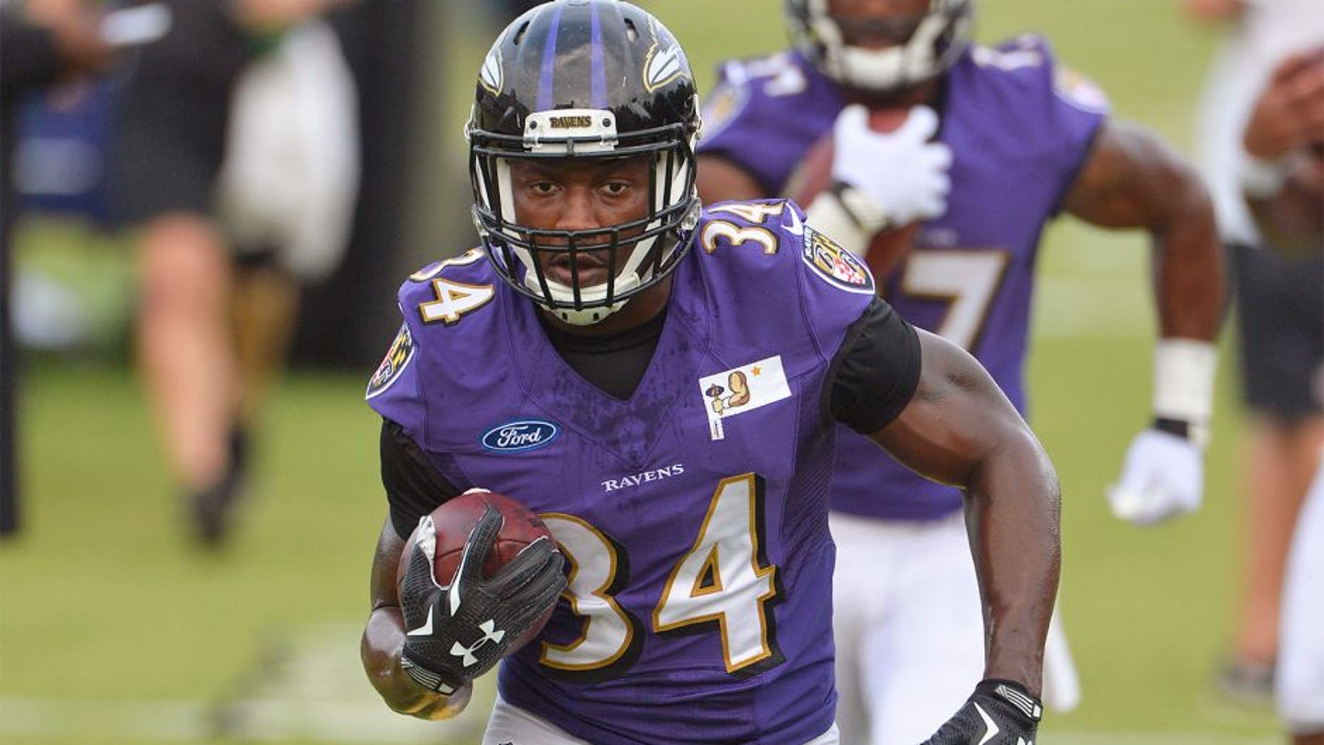 Jul 30, 2015; Owings Mills, MD, USA; Baltimore Ravens running back Lorenzo Taliaferro (34) carries the ball during drills on day one of training camp at Under Armour Performance Center. Mandatory Credit: Tommy Gilligan-USA TODAY Sports
