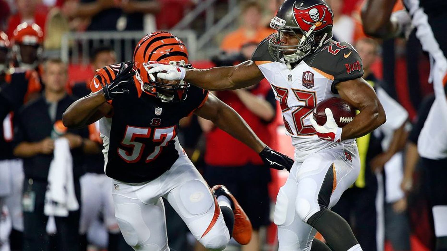 Aug 24, 2015; Tampa, FL, USA; Tampa Bay Buccaneers running back Doug Martin (22) runs with the ball as Cincinnati Bengals outside linebacker Vincent Rey (57) attempted to defend during the first quarter at Raymond James Stadium. Mandatory Credit: Kim Klement-USA TODAY Sports