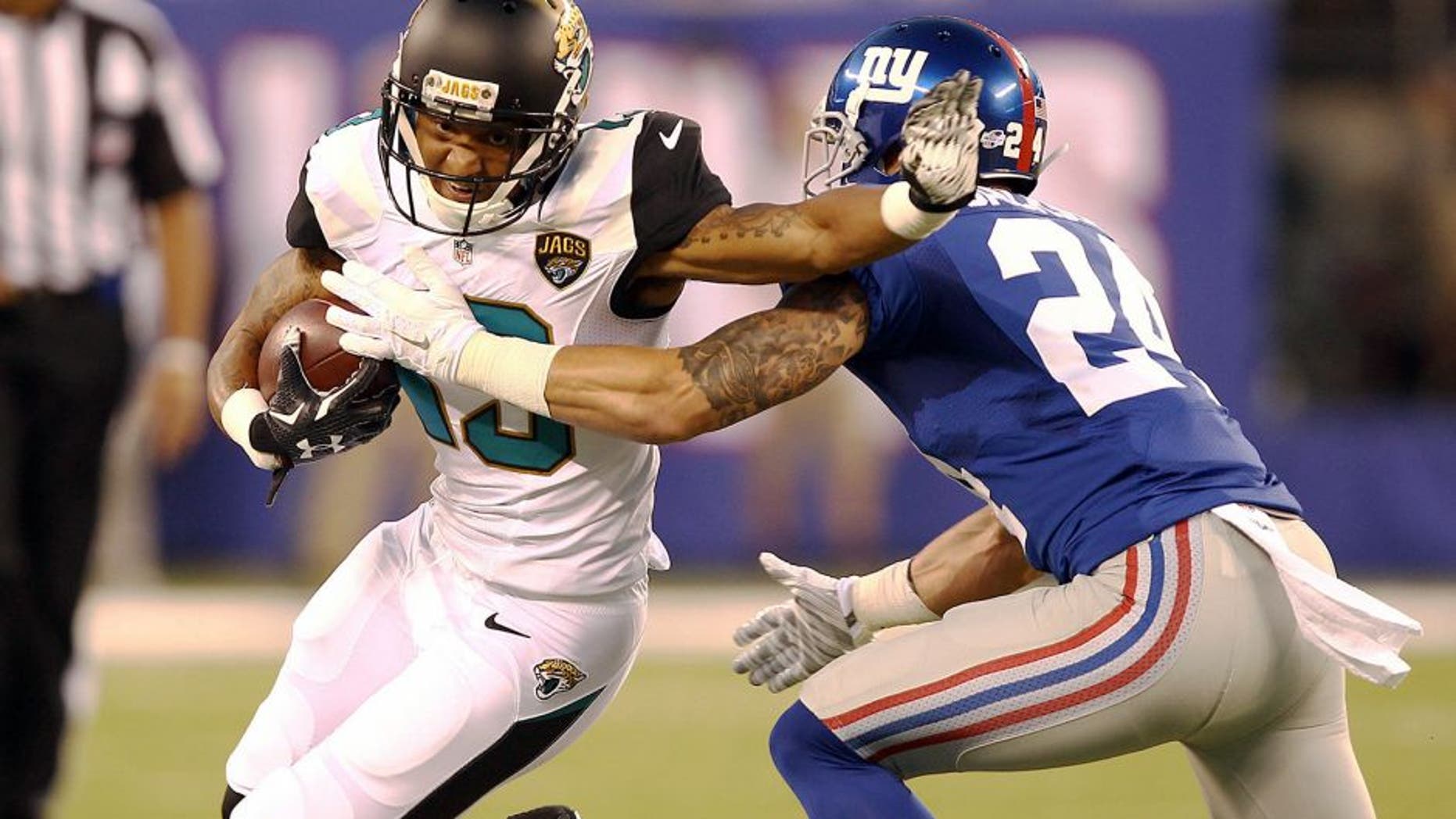Aug 22, 2015; East Rutherford, NJ, USA; Jacksonville Jaguars wide receiver Rashad Greene (13) catches a ball in front of New York Giants safety Bennett Jackson (24) during the first half at MetLife Stadium. Mandatory Credit: Danny Wild-USA TODAY Sports