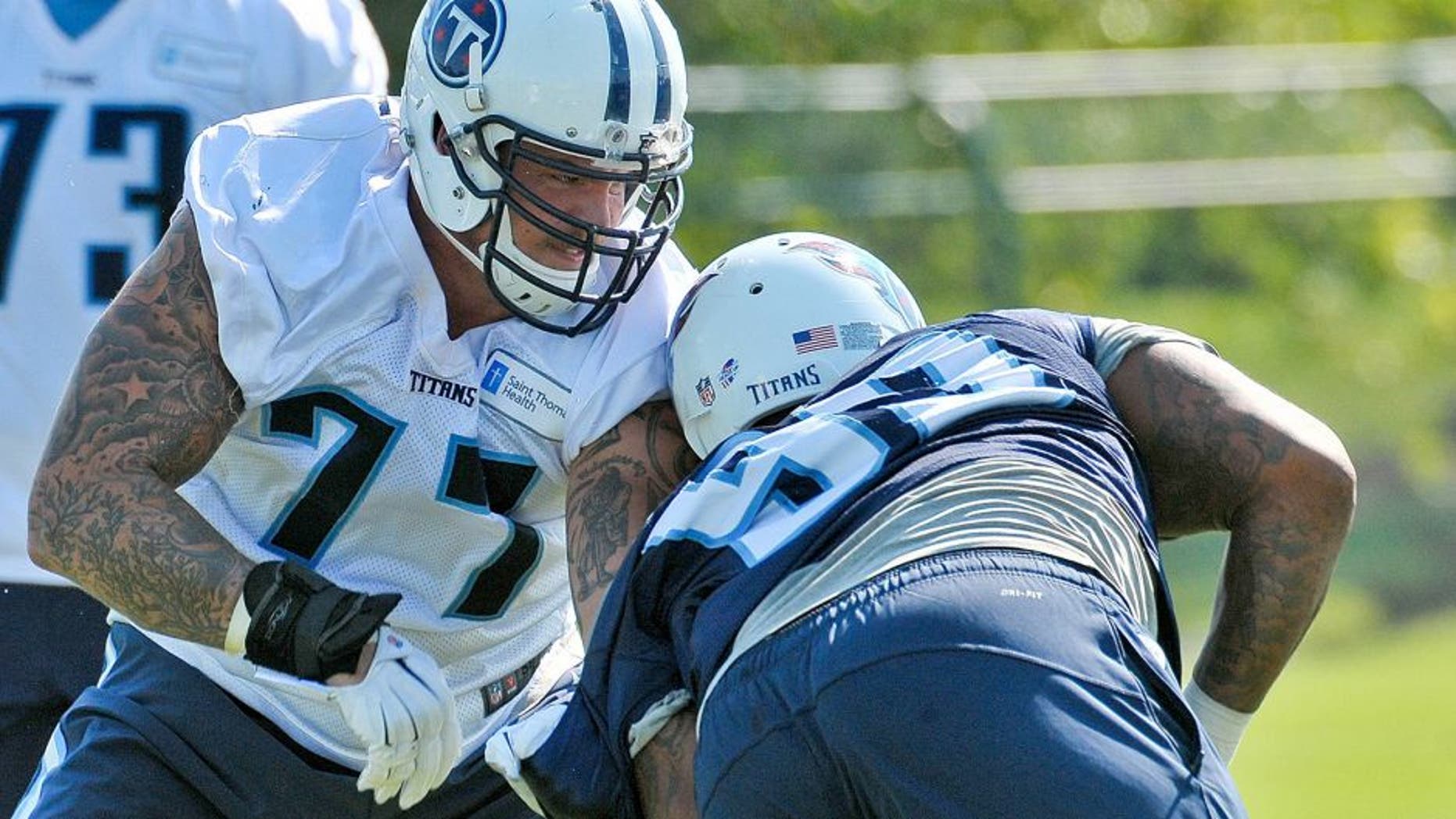 Aug 21, 2015; Nashville, TN, USA; Tennessee Titans tackle Taylor Lewan (77) works out against titans defensive tackle Jurrell Casey (99) during training camp at Saint Thomas Sports Park. Mandatory Credit: Jim Brown-USA TODAY Sports