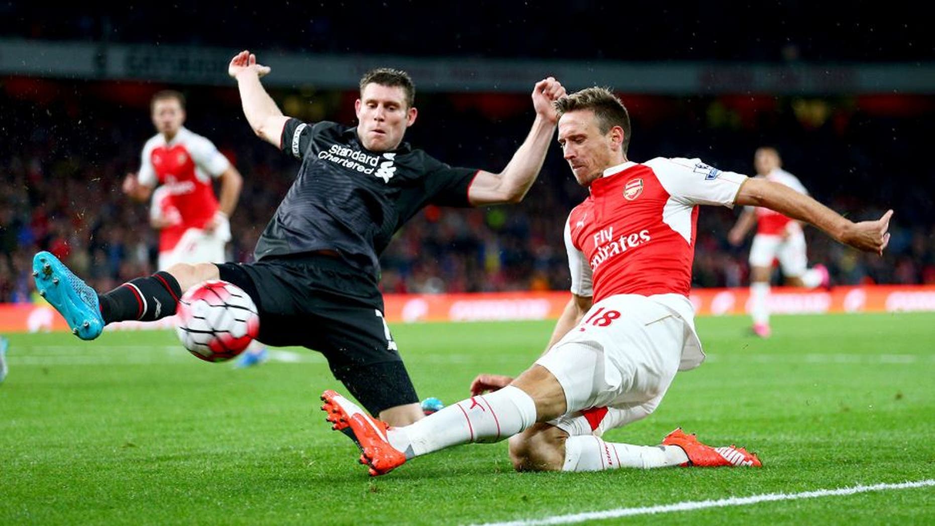 LONDON, ENGLAND - AUGUST 24: Nacho Monreal of Arsenal is closed down by James Milner of Liverpool during the Barclays Premier League match between Arsenal and Liverpool at Emirates Stadium on August 24, 2015 in London, England. (Photo by Clive Mason/Getty Images)
