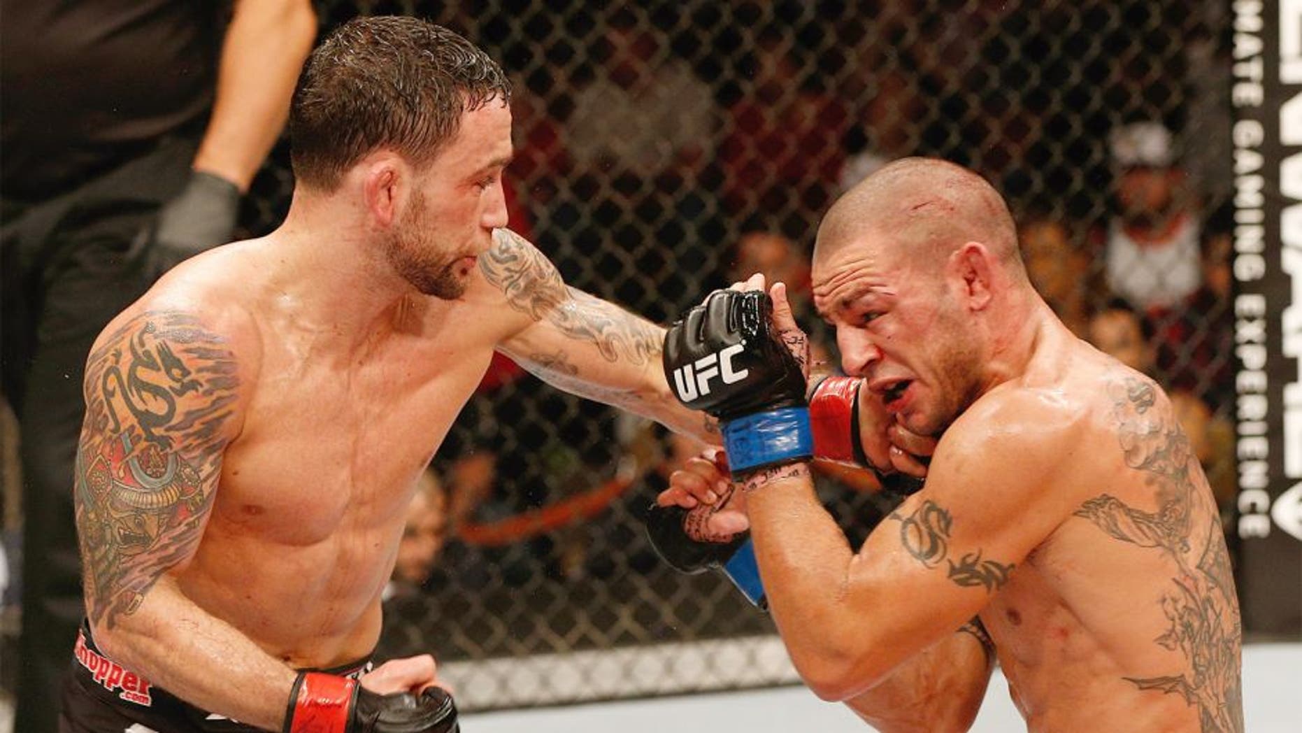 AUSTIN, TX - NOVEMBER 22: (L-R) Frankie Edgar punches Cub Swanson in their featherweight bout during the UFC Fight Night event at The Frank Erwin Center on November 22, 2014 in Austin, Texas. (Photo by Josh Hedges/Zuffa LLC/Zuffa LLC via Getty Images)