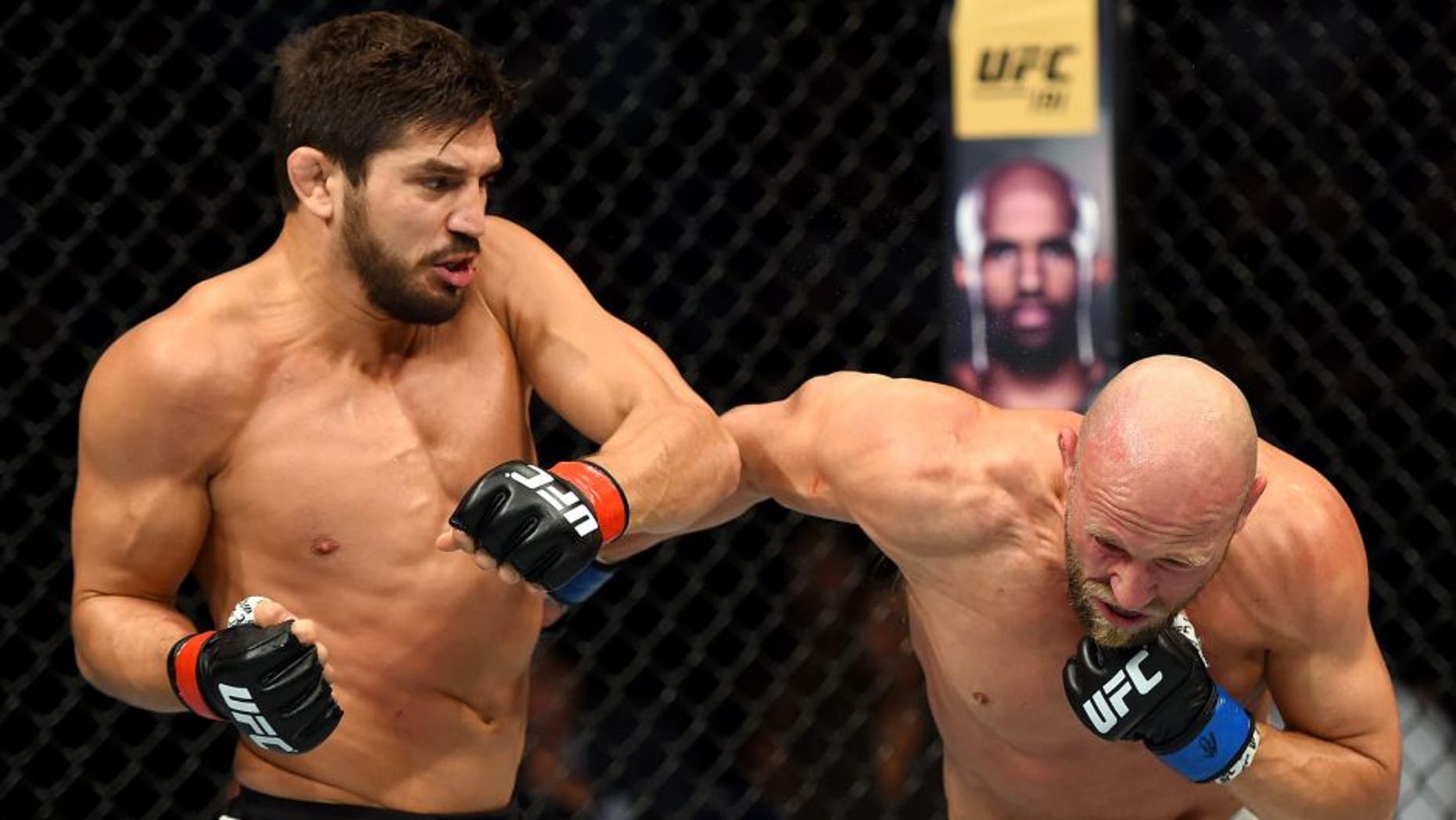 SASKATOON, SK - AUGUST 23: (L-R) Patrick Cote punches Josh Burkman of the United States in their welterweight bout during the UFC event at the SaskTel Centre on August 23, 2015 in Saskatoon, Saskatchewan, Canada. (Photo by Jeff Bottari/Zuffa LLC/Zuffa LLC via Getty Images)