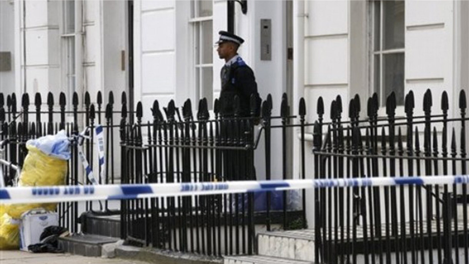 Aug. 25: A British Community Police Support Officer stands quard outside a house in central London, near the headquarters of MI6, where a man believed to be a British spy has been found dead in a flat.