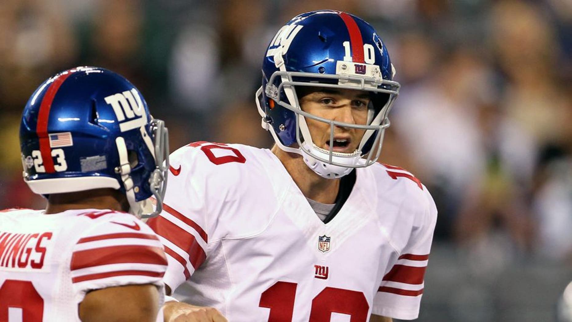 Aug 22, 2014; East Rutherford, NJ, USA; New York Giants quarterback Eli Manning (10) directs running back Rashad Jennings (23) against the New York Jets during the first quarter at MetLife Stadium. Mandatory Credit: Adam Hunger-USA TODAY Sports