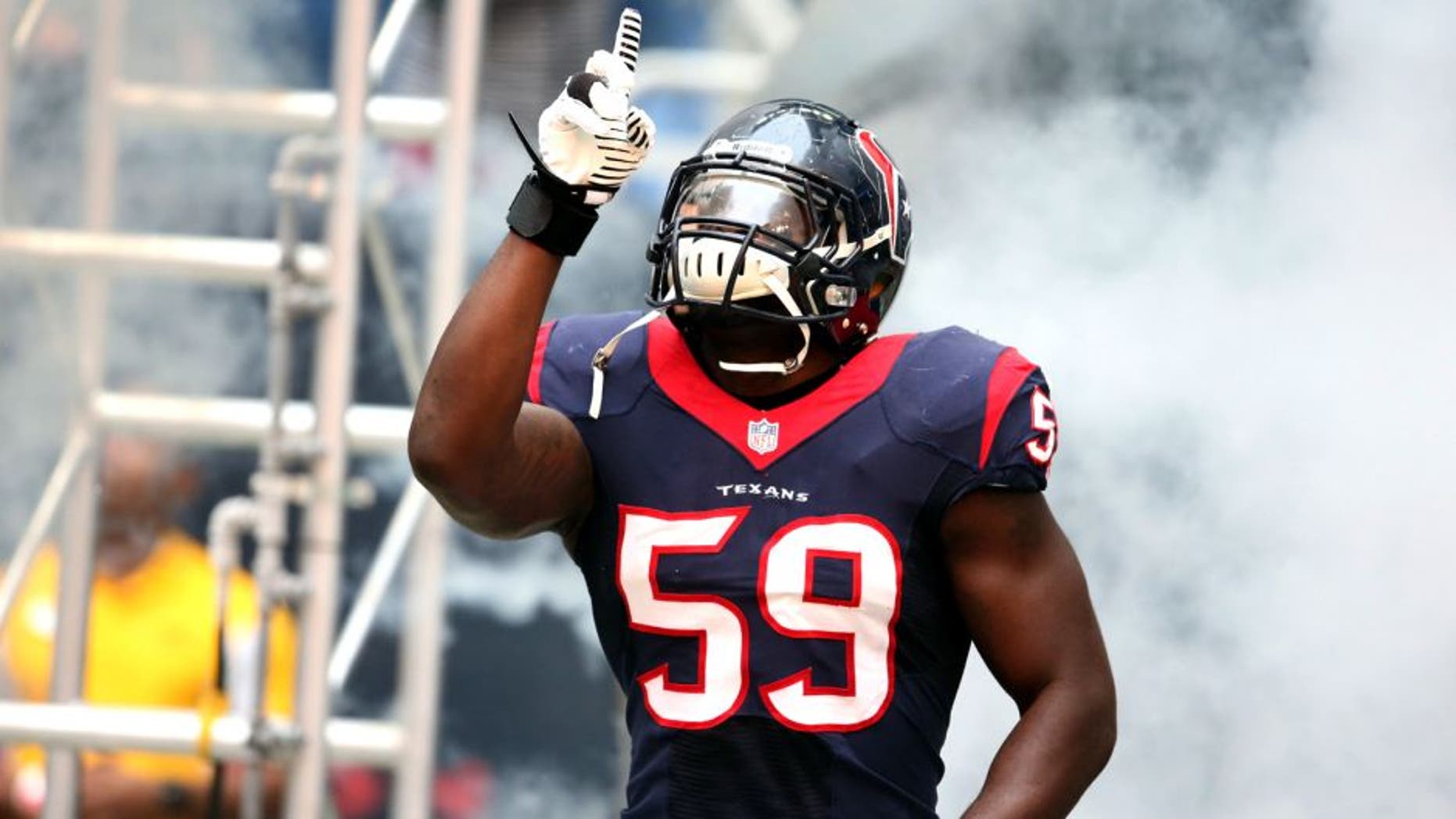 Dec 1, 2013; Houston, TX, USA; Houston Texans linebacker Whitney Mercilus (59) points as he is introduced prior to the game against the New England Patriots at Reliant Stadium. Mandatory Credit: Matthew Emmons-USA TODAY Sports