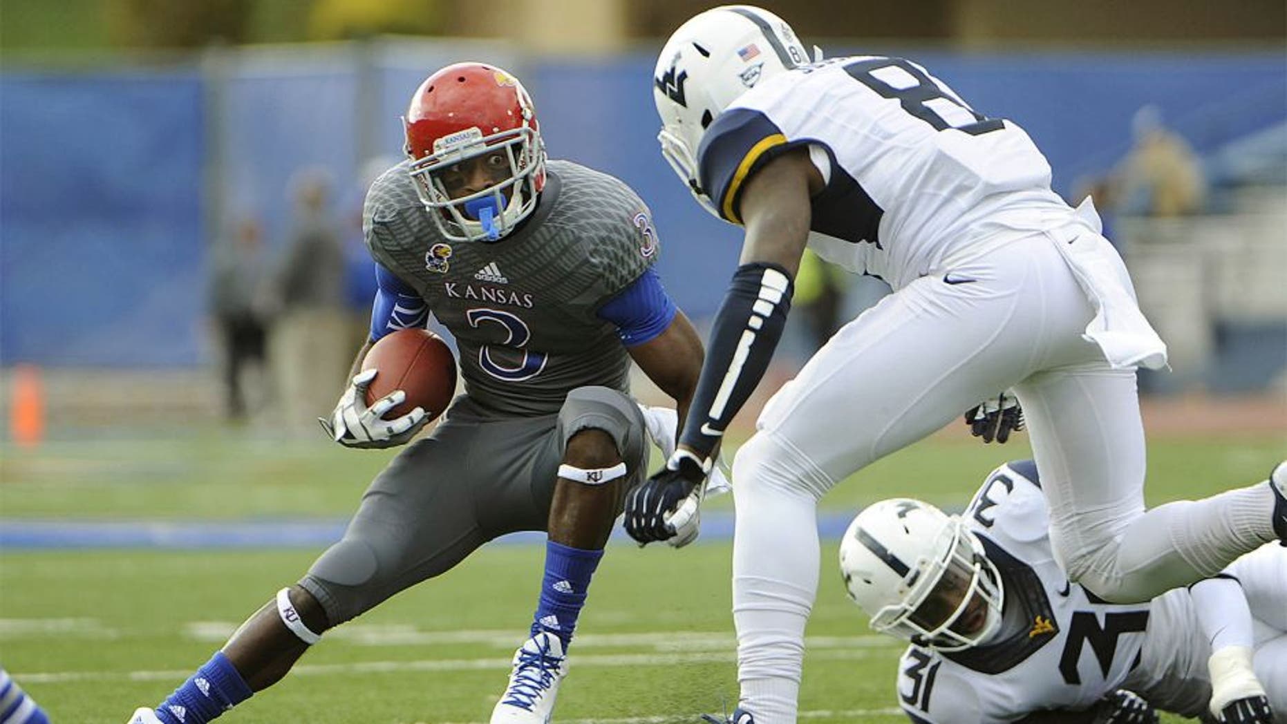 Nov 16, 2013; Lawrence, KS, USA; Kansas Jayhawks running back Tony Pierson (3) runs for yardage against West Virginia Mountaineers linebacker Isaiah Bruce (31) and safety Karl Joseph (8) in the first half at Memorial Stadium. Mandatory Credit: John Rieger-USA TODAY Sports