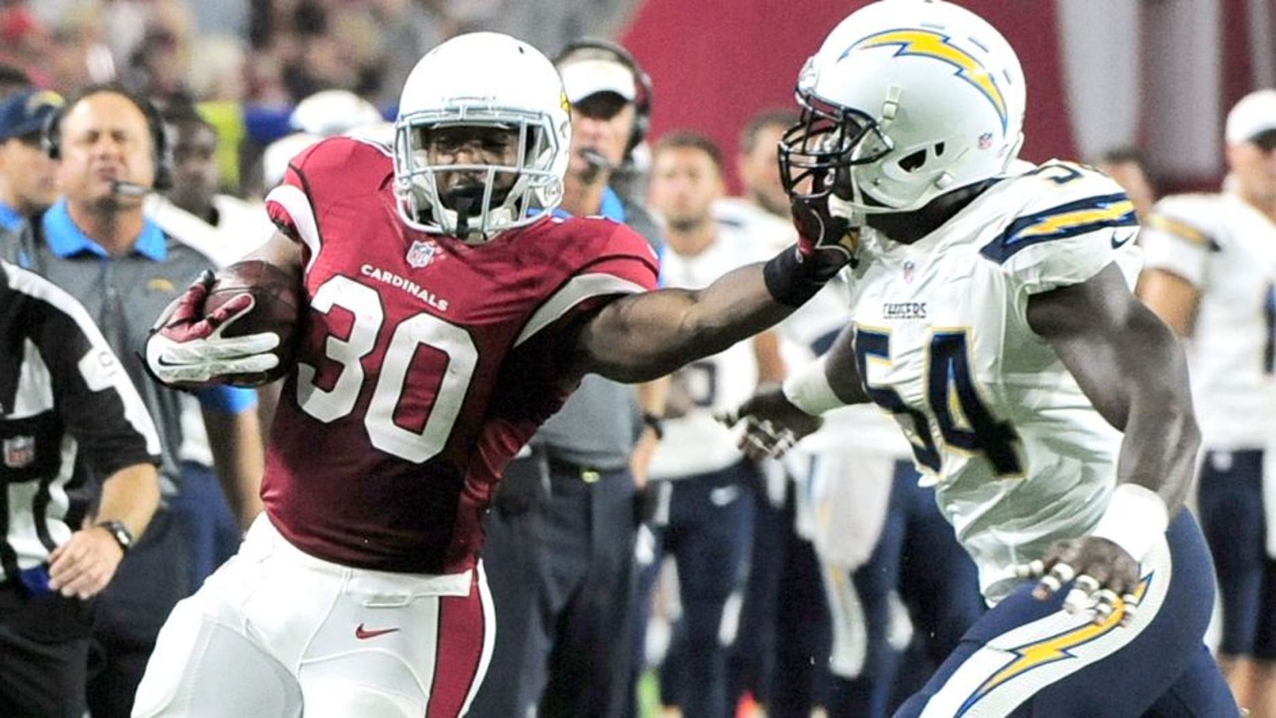 Aug 22, 2015; Glendale, AZ, USA; Arizona Cardinals running back Stepfan Taylor (30) stiff arms San Diego Chargers outside linebacker Melvin Ingram (54) during the first half at University of Phoenix Stadium. The Chargers won 22-19. Mandatory Credit: Joe Camporeale-USA TODAY Sports