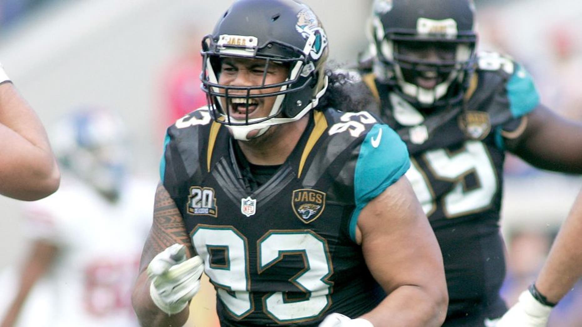 Nov 30, 2014; Jacksonville, FL, USA; Jacksonville Jaguars defensive end Tyson Alualu (93) reacts after a sack agains the New York Giants in the fourth quarter at EverBank Field. The Jaguars won 25-24. Mandatory Credit: Phil Sears-USA TODAY Sports