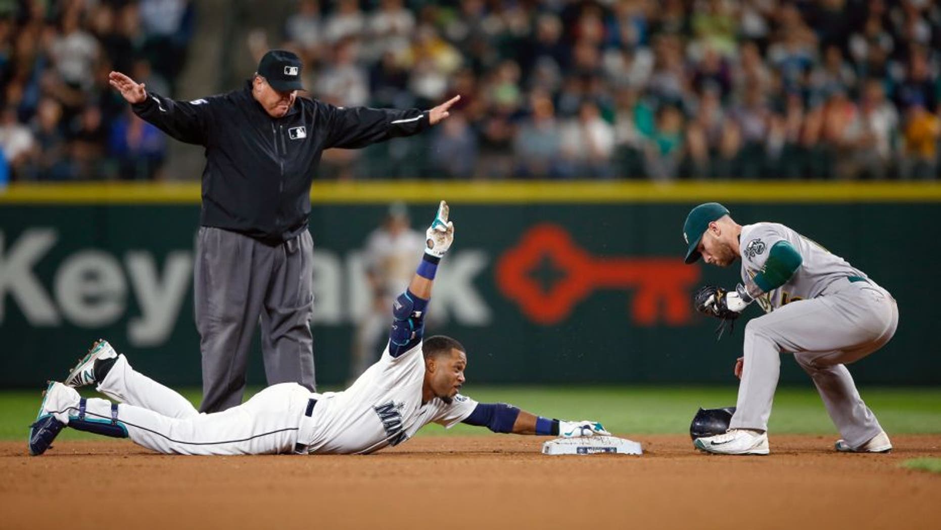 SEATTLE, WA - AUGUST 25: Robinson Cano #22 of the Seattle Mariners gestures after doubling against second baseman Brett Lawrie #15 of the Oakland Athletics in the seventh inning at Safeco Field on August 25, 2015 in Seattle, Washington. The double gave Cano 30 for 11 consecutive seasons. (Photo by Otto Greule Jr/Getty Images)
