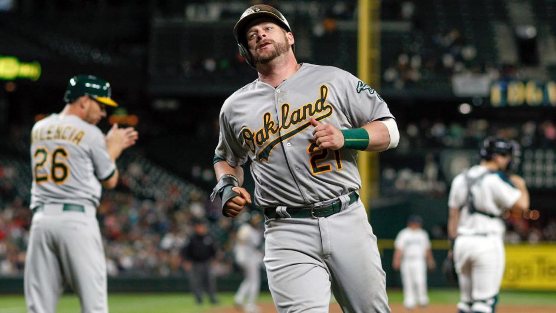 SEATTLE, WA - AUGUST 24: Stephen Vogt #21 of the Oakland Athletics heads to the dugout after scoring in the ninth inning against the Seattle Mariners at Safeco Field on August 24, 2015 in Seattle, Washington. (Photo by Otto Greule Jr/Getty Images)