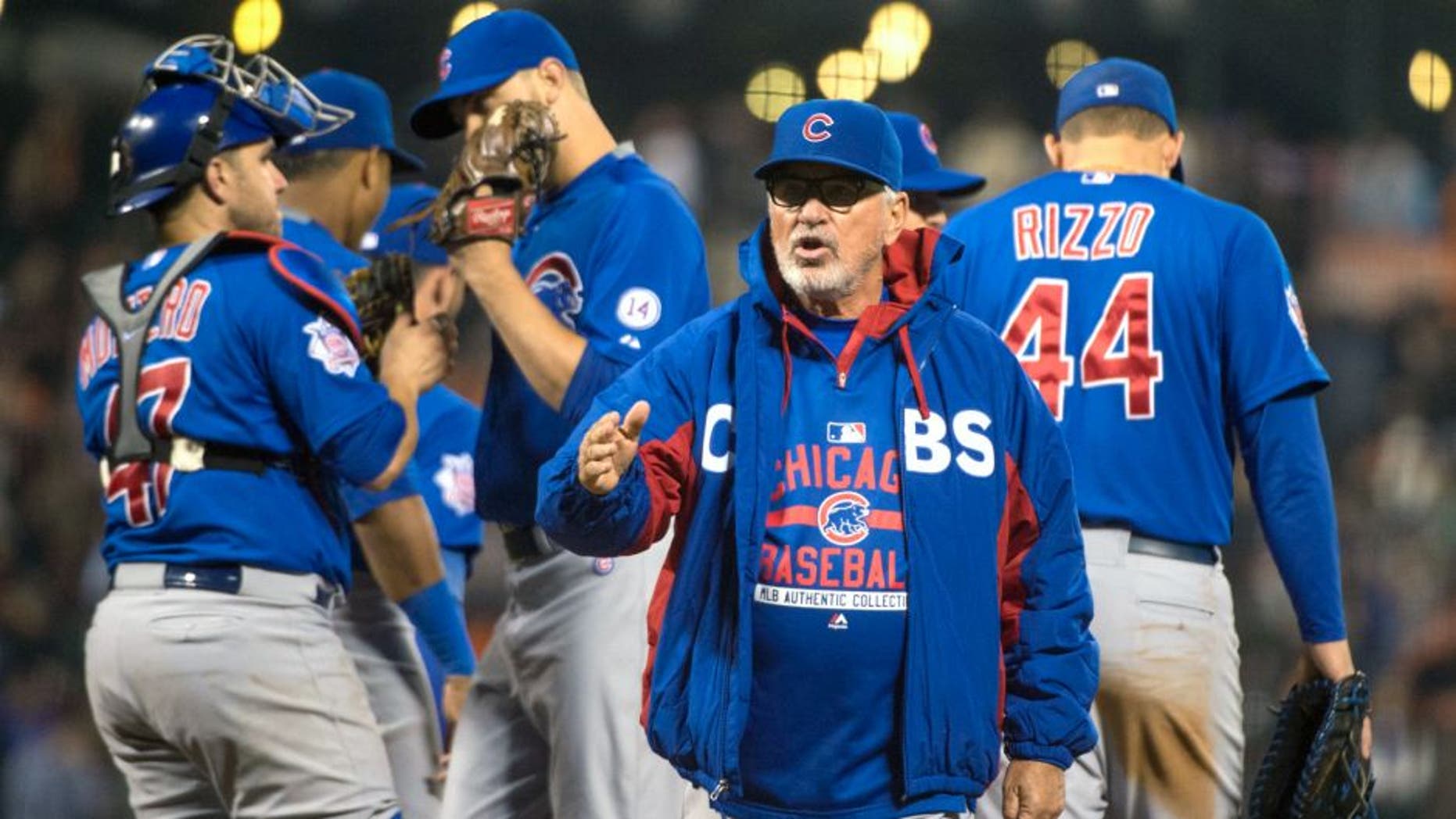 August 25, 2015; San Francisco, CA, USA; Chicago Cubs manager Joe Maddon (70) completes a pitching change during the seventh inning against the San Francisco Giants at AT&T Park. Mandatory Credit: Kyle Terada-USA TODAY Sports