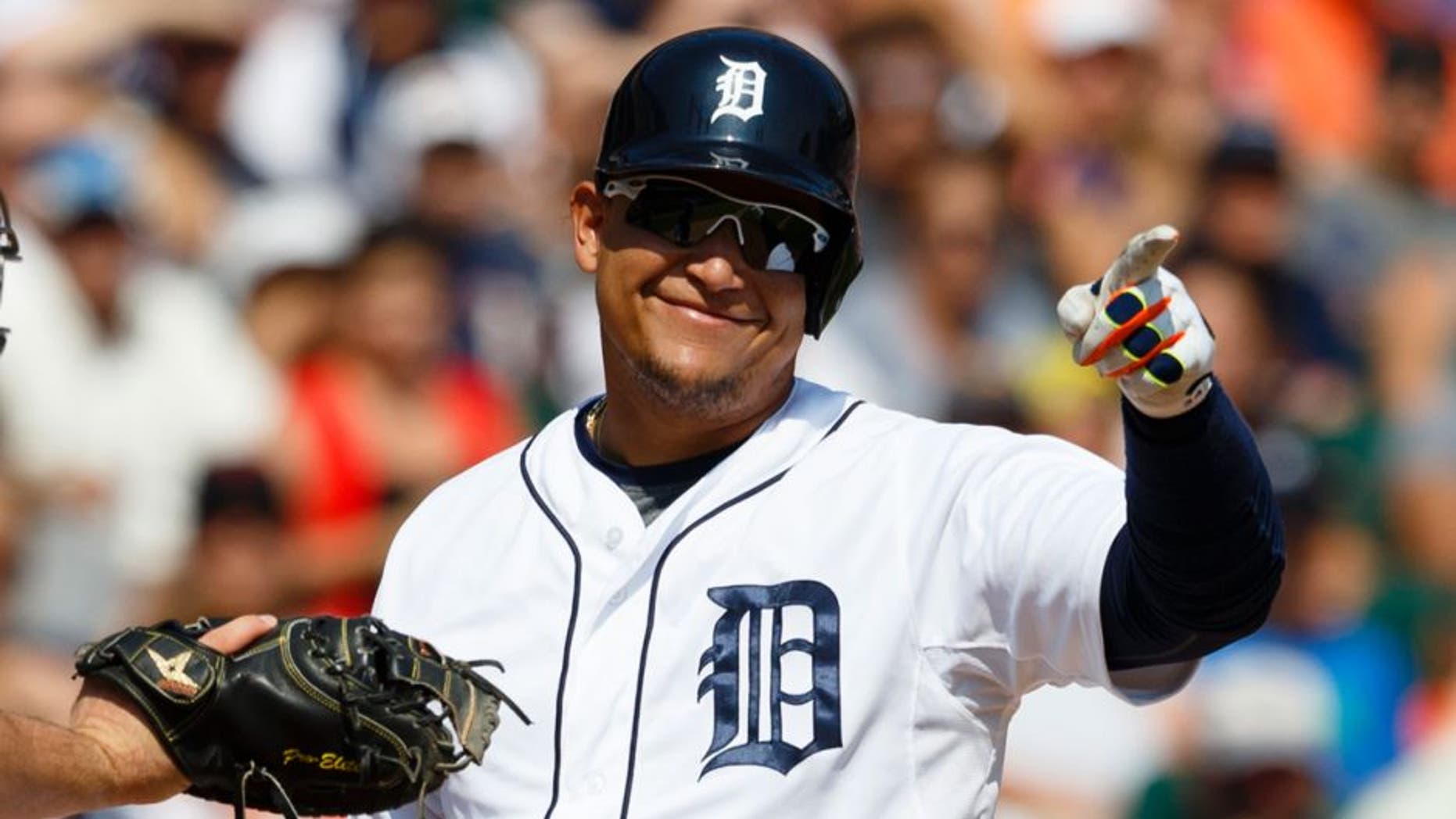 Aug 23, 2015; Detroit, MI, USA; Detroit Tigers designated hitter Miguel Cabrera (24) reacts to a called swing by first base umpire Ron Kulpa (not pictured) as Texas Rangers catcher Chris Gimenez (38) tags him in the seventh inning at Comerica Park. Mandatory Credit: Rick Osentoski-USA TODAY Sports