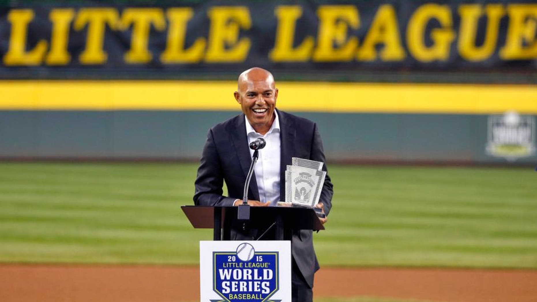 Former New York Yankees closer Mariano Rivera smiles as he is honored before a United States elimination baseball game between Bonita, Calif. and Bowling Green, Ky. at the Little League World Series, Tuesday, Aug. 25, 2015, in South Williamsport, Pa. Rivera was inducted into the Little League Hall of Excellence on Tuesday night between games of its World Series. (AP Photo/Gene J. Puskar)