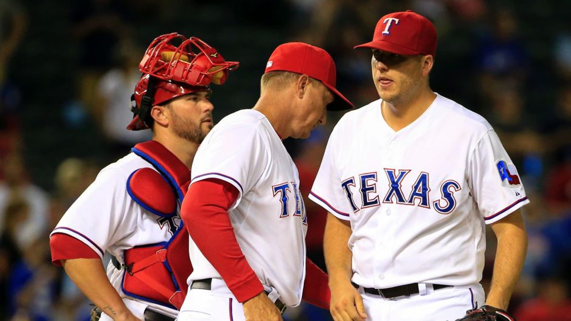 Aug 25, 2015; Arlington, TX, USA; Texas Rangers manager Jeff Banister (middle) takes out relief pitcher Shawn Tolleson (37) during the ninth inning against the Toronto Blue Jays at Globe Life Park in Arlington. Mandatory Credit: Kevin Jairaj-USA TODAY Sports