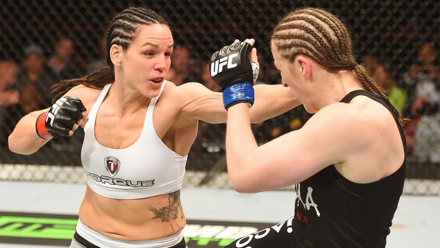 MONTREAL, QC - APRIL 25: (L-R) Alexis Davis of Canada punches Sarah Kaufman of Canada in their women's bantamweight bout during the UFC 186 event at the Bell Centre on April 25, 2015 in Montreal, Quebec, Canada. (Photo by Josh Hedges/Zuffa LLC/Zuffa LLC via Getty Images)