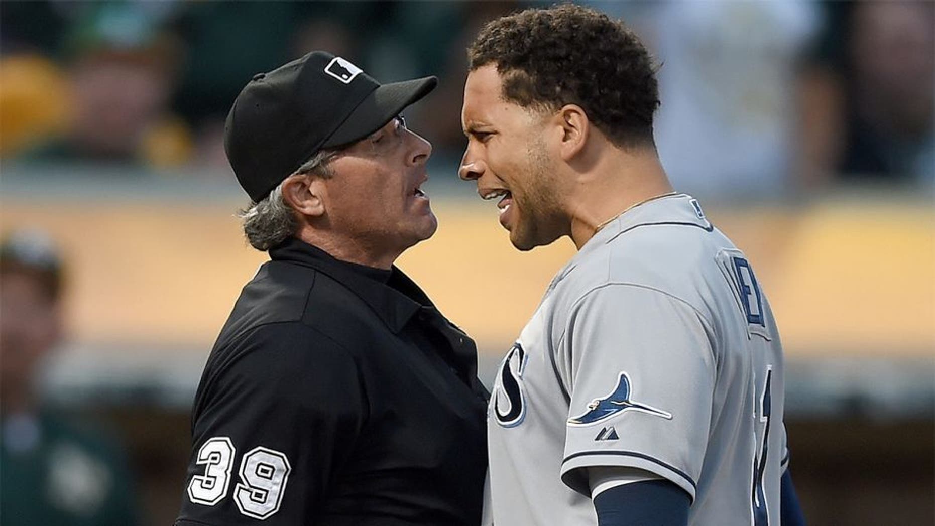 OAKLAND, CA - AUGUST 22: James Loney #21 of the Tampa Bay Rays argues with home plate umpire Paul Nauert #39 after Nauert threw Loney out of the game against the Oakland Athletics in the top of the six inning at O.co Coliseum on August 22, 2015 in Oakland, California. (Photo by Thearon W. Henderson/Getty Images)