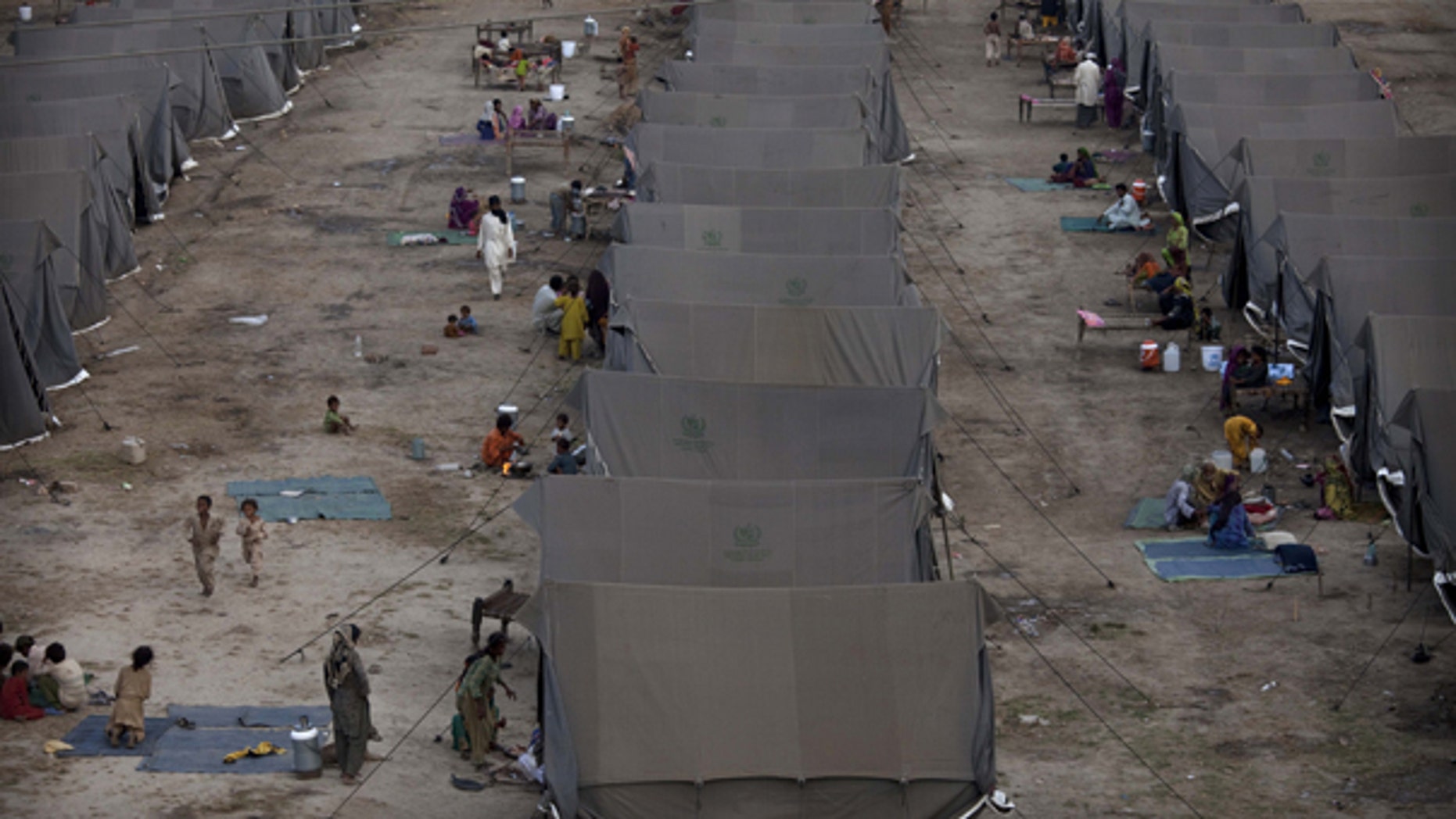Aug. 26: Pakistanis displaced by flooding sit outside tents at a temporary camp operated by the Army in southern Pakistan.