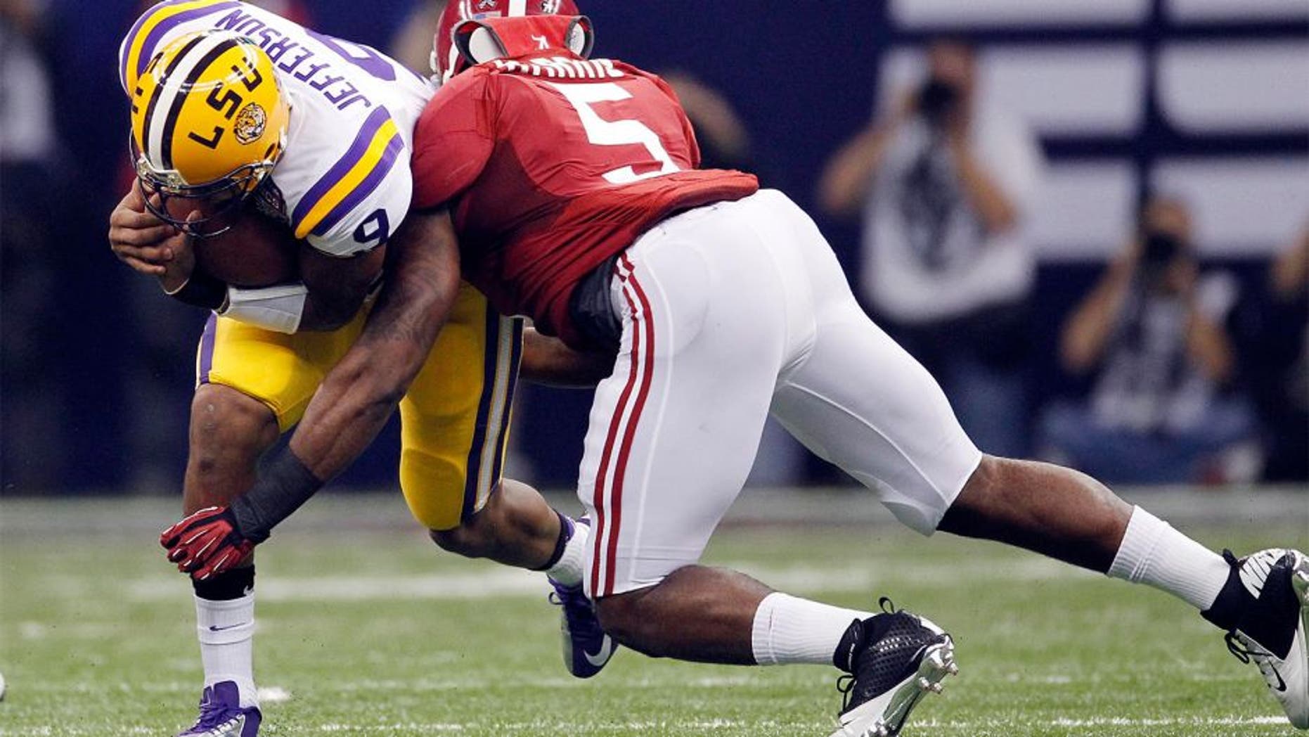 Jan 9, 2012; New Orleans, LA, USA; LSU Tigers quarterback Jordan Jefferson (9) is tackled by Alabama Crimson Tide linebacker Jerrell Harris (5) during the first half of the 2012 BCS National Championship game at the Mercedes-Benz Superdome. Mandatory Credit: Derick E. Hingle-USA TODAY Sports
