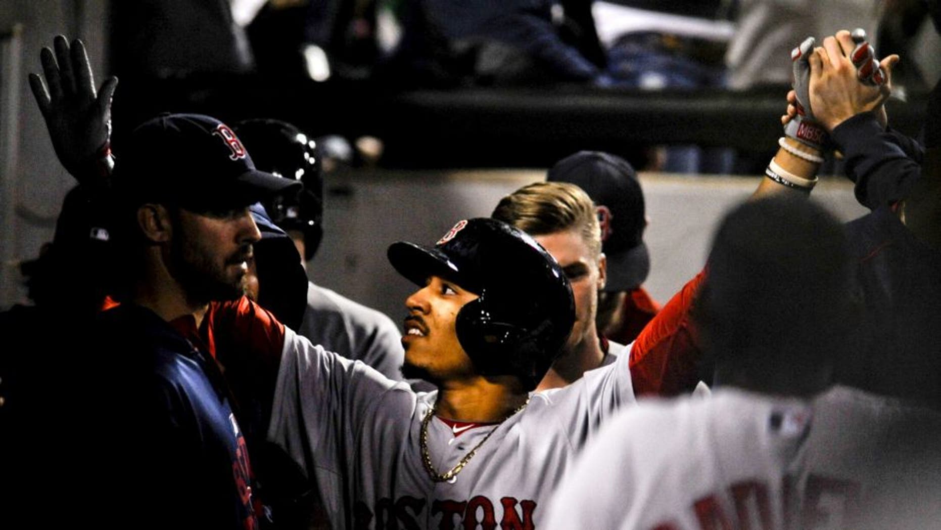 Aug 25, 2015; Chicago, IL, USA; Boston Red Sox center fielder Mookie Betts (50) celebrates with teammates after he scores on an RBI double by Boston Red Sox third baseman Pablo Sandoval (48) during the sixth inning against the Chicago White Sox at U.S Cellular Field. Mandatory Credit: Matt Marton-USA TODAY Sports