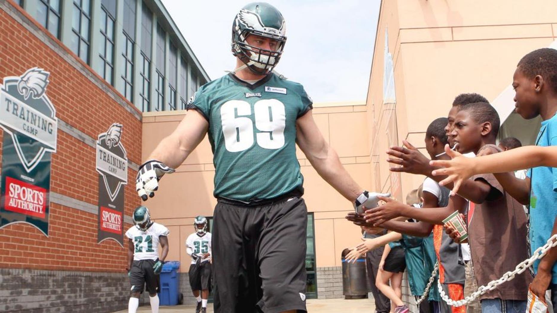 Jul 26, 2014; Philadelphia, PA, USA; Philadelphia Eagles guard Evan Mathis (69) is greeted by fans as he runs onto the field for the start of training camp at the Novacare Complex. Mandatory Credit: Bill Streicher-USA TODAY Sports