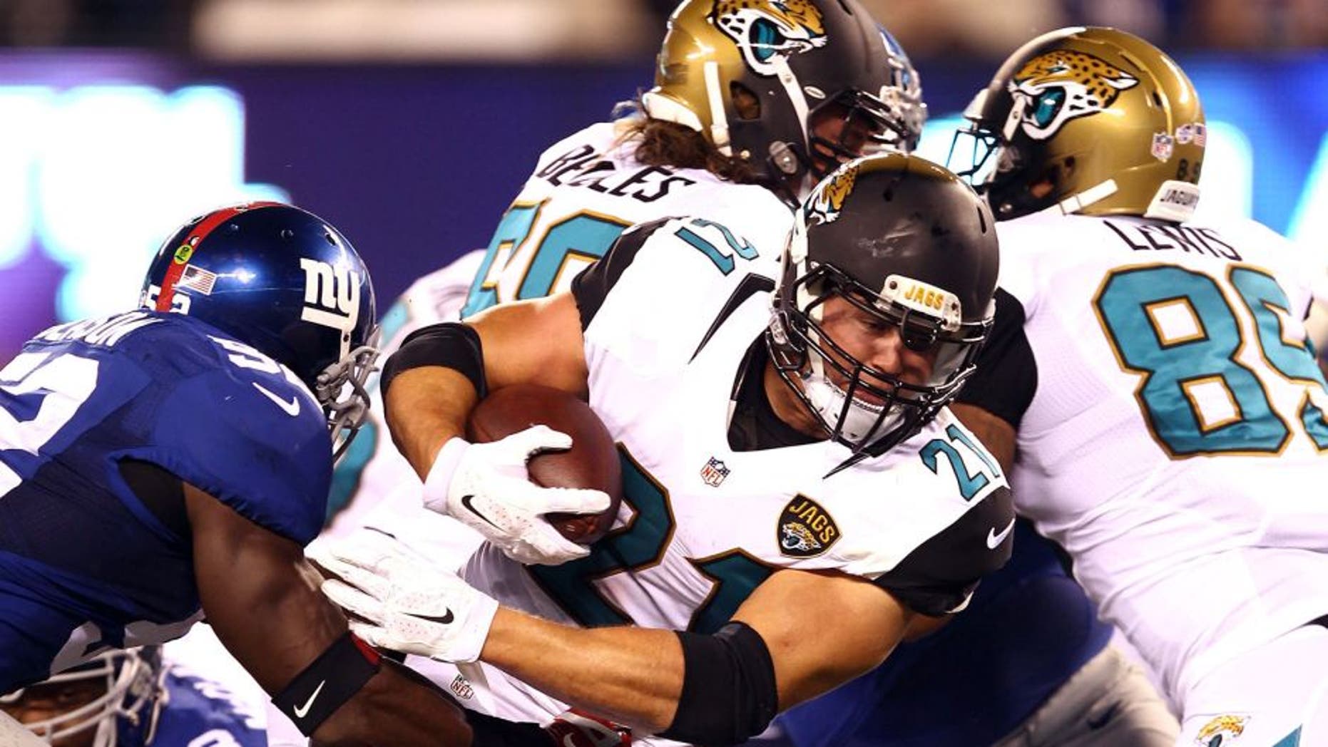 Aug 22, 2015; East Rutherford, NJ, USA; Jacksonville Jaguars running back Toby Gerhart (21) rushes the ball against the New York Giants defense during the first half at MetLife Stadium. Mandatory Credit: Danny Wild-USA TODAY Sports