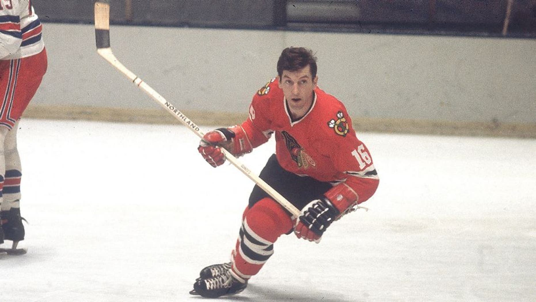 Canadian professional ice hockey player Ronald 'Chico' Maki #16 of the Chicago Blackhawks skates on the ice as an opponent looks on during a game against the New York Rangers, Madison Square Garden, New York, mid 20th Century. Maki played for Chicago from 1961 to 1976. (Photo by Melchior DiGiacomo/Getty Images)