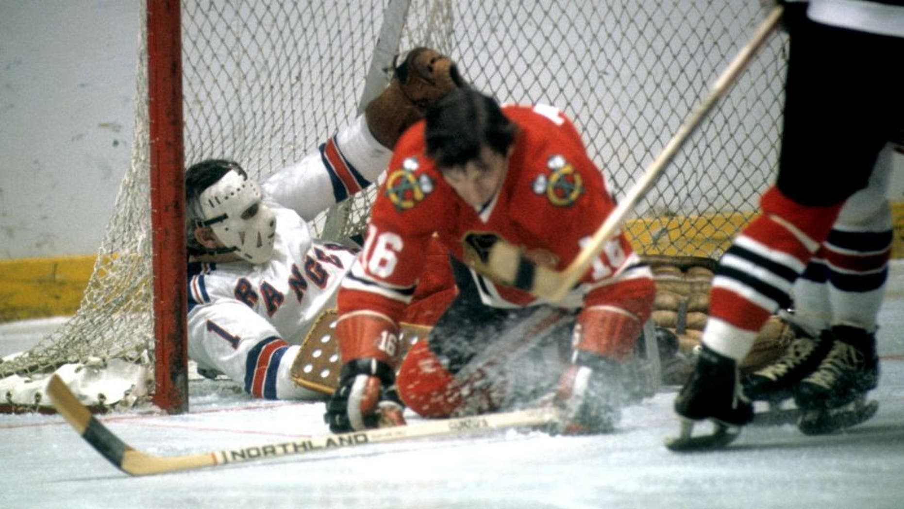 NEW YORK, NY - 1972: Goalie Ed Giacomin #1 of the New York Rangers is pushed into the net by Chico Maki #16 of the Chicago Blackhawks during their game circa 1972 at the Madison Square Garden in New York, New York. (Photo by Melchior DiGiacomo/Getty Images)