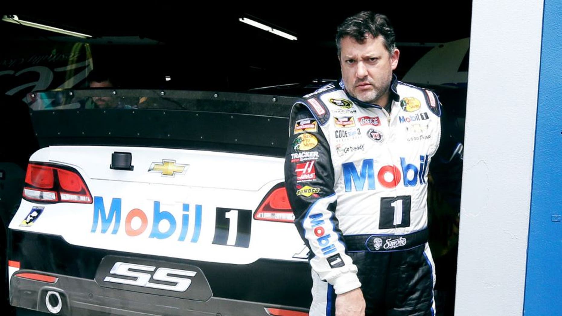 Tony Stewart leaves the garage after a practice session Friday, Aug. 14, 2015, for Sunday's NASCAR Sprint Cup series auto race at Michigan International Speedway in Brooklyn, Mich. (AP Photo/Carlos Osorio)