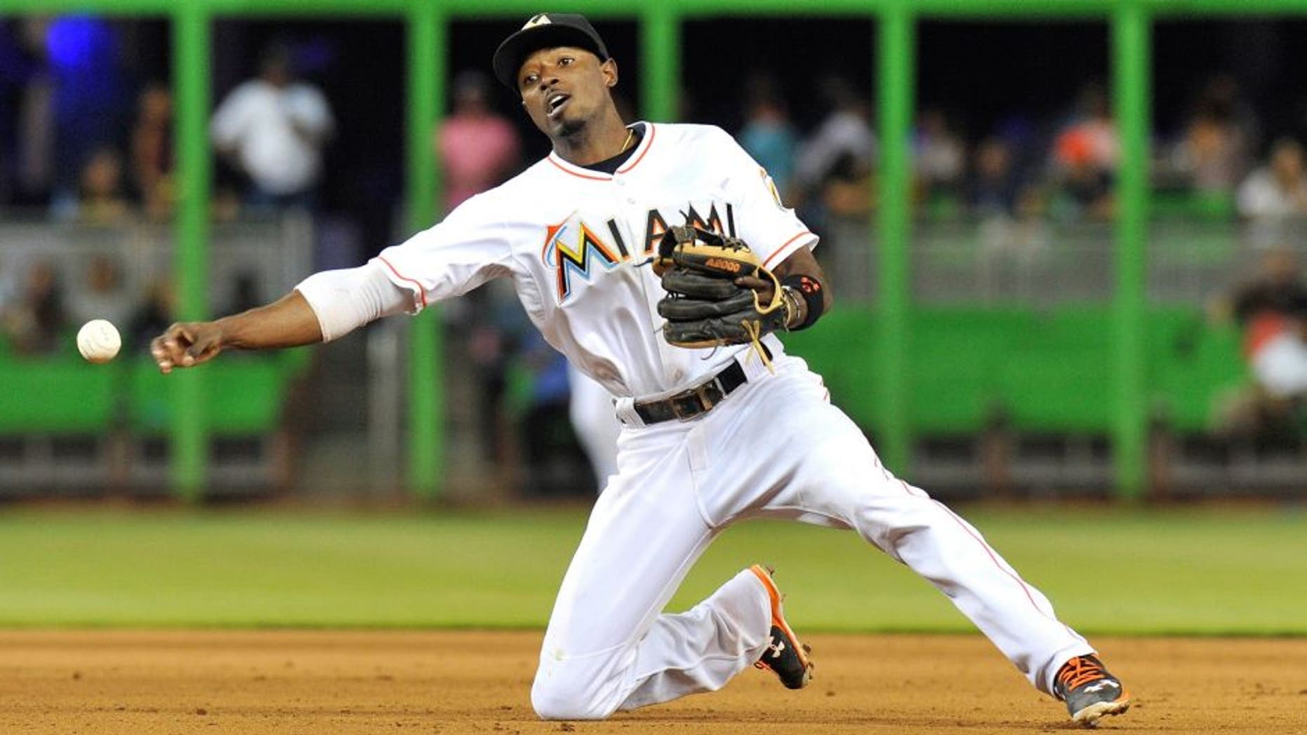 Aug 24, 2015; Miami, FL, USA; Miami Marlins second baseman Dee Gordon (9) throws over to first base during the eighth inning against the Pittsburgh Pirates at Marlins Park. Mandatory Credit: Steve Mitchell-USA TODAY Sports