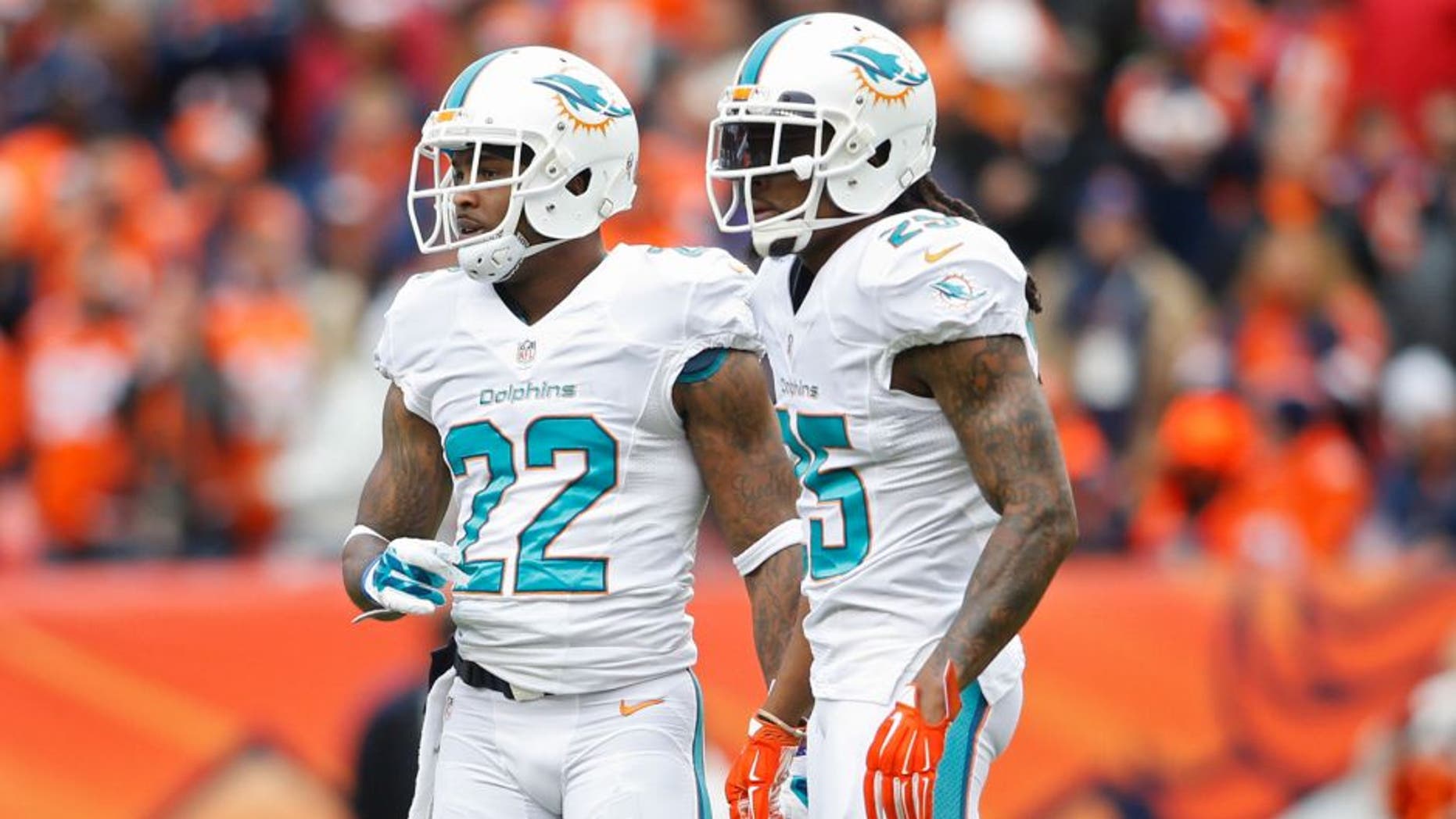 Nov 23, 2014; Denver, CO, USA; Miami Dolphins cornerback Jamar Taylor (22) and Miami Dolphins free safety Louis Delmas (25) during the game against the Denver Broncos at Sports Authority Field at Mile High. Mandatory Credit: Chris Humphreys-USA TODAY Sports
