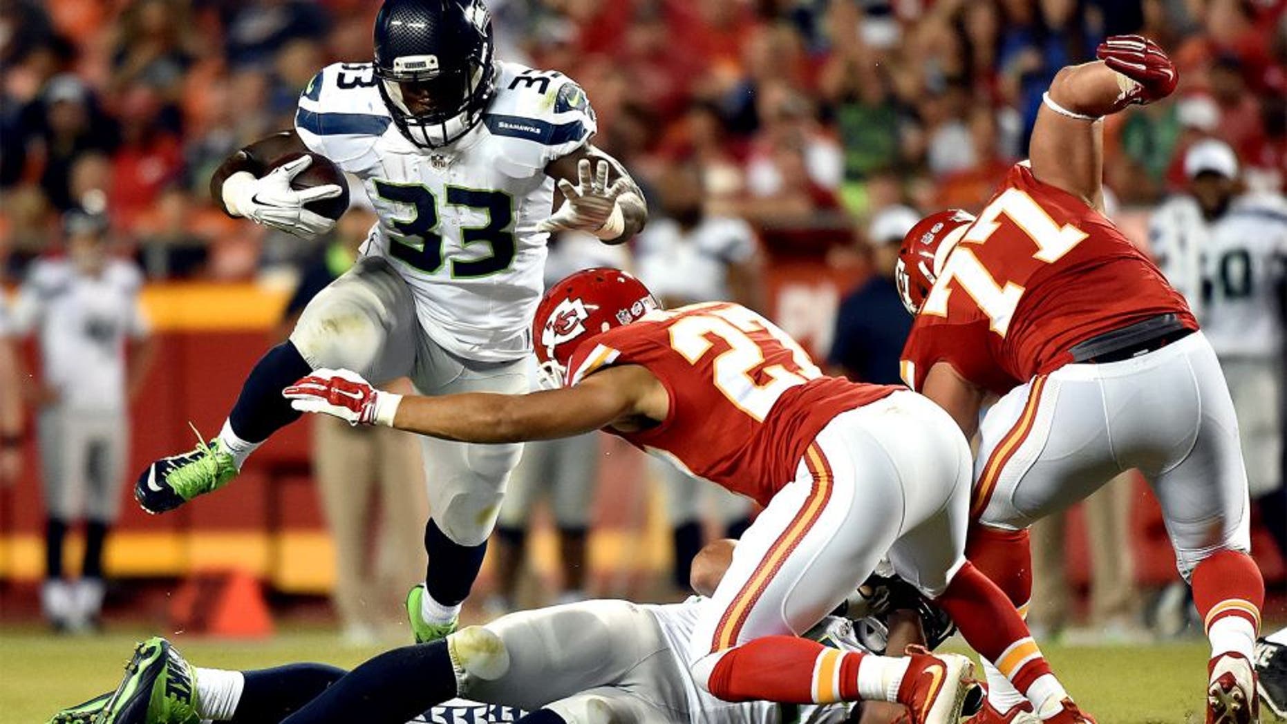 KANSAS CITY, MO - AUGUST 21: Running back Christine Michael #33 of the Seattle Seahawks carries the ball during the preseason game against the Kansas City Chiefs at Arrowhead Stadium on August 21, 2015 in Kansas City, Missouri. (Photo by Peter Aiken/Getty Images)