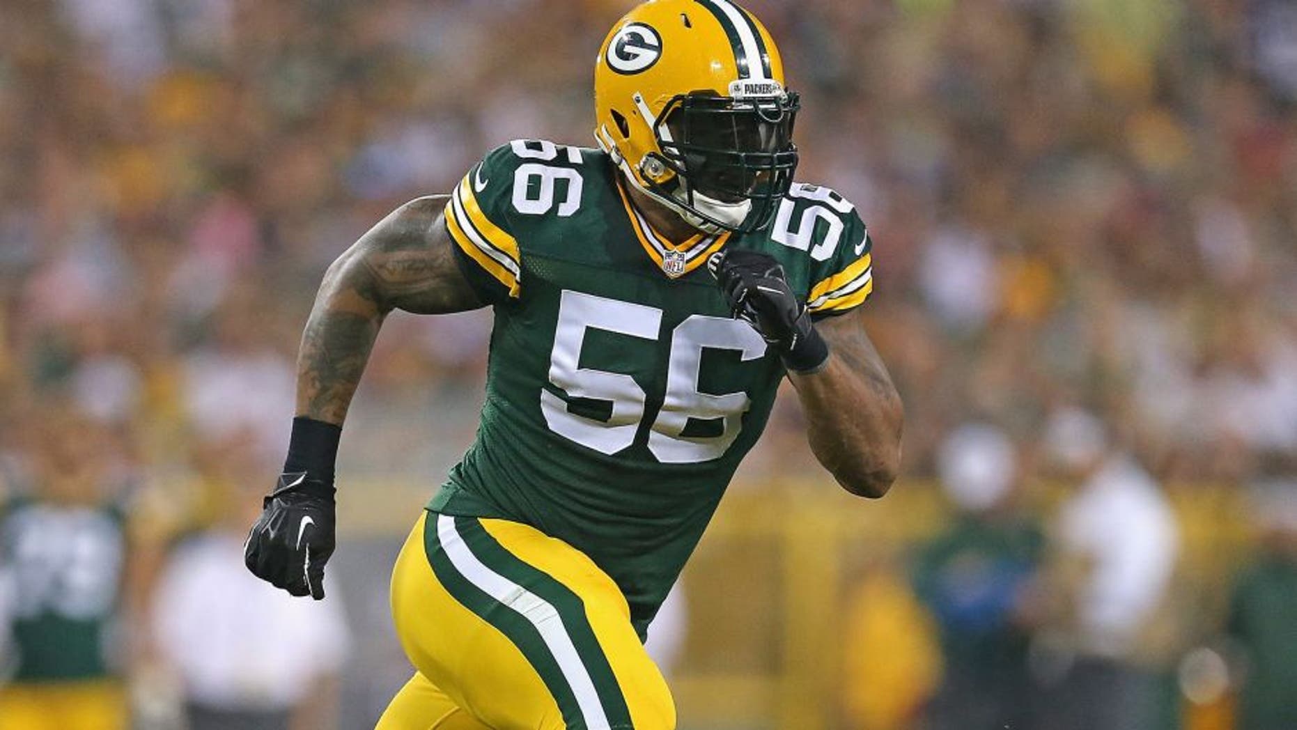 GREEN BAY, WI - AUGUST 22: Julius Peppers #56 of the Green Bay Packers rushes against the Oakland Raiders during a preseason game at Lambeau Field on August 22, 2014 in Green Bay, Wisconsin. The Packers defeated the Raiders 31-21. (Photo by Jonathan Daniel/Getty Images) *** Local Caption *** Julius Peppers