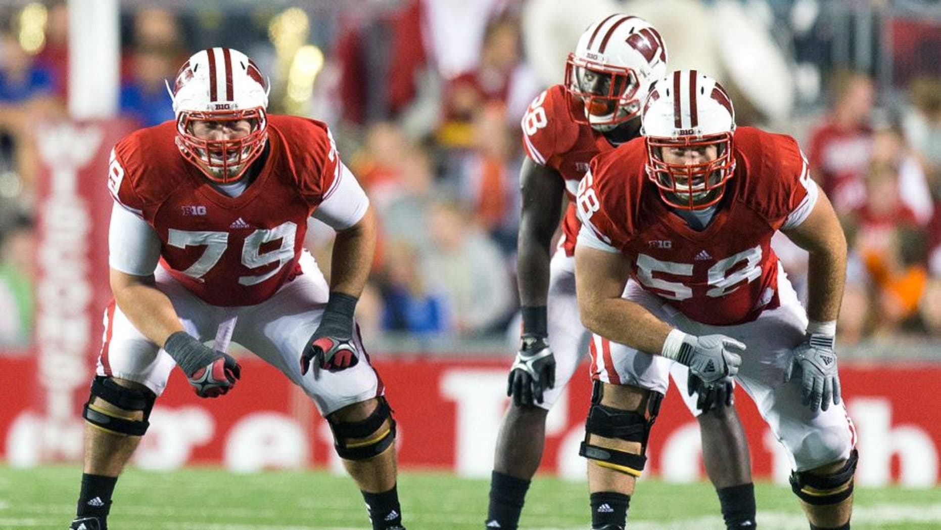 Sep 15, 2012; Madison, WI, USA; Wisconsin Badgers offensive linemen Ryan Groy (79) and Rick Wagner (58) line up for a play during the game against the Utah State Aggies at Camp Randall Stadium. Wisconsin defeated Utah State 16-14. Mandatory Credit: Jeff Hanisch-USA TODAY Sports