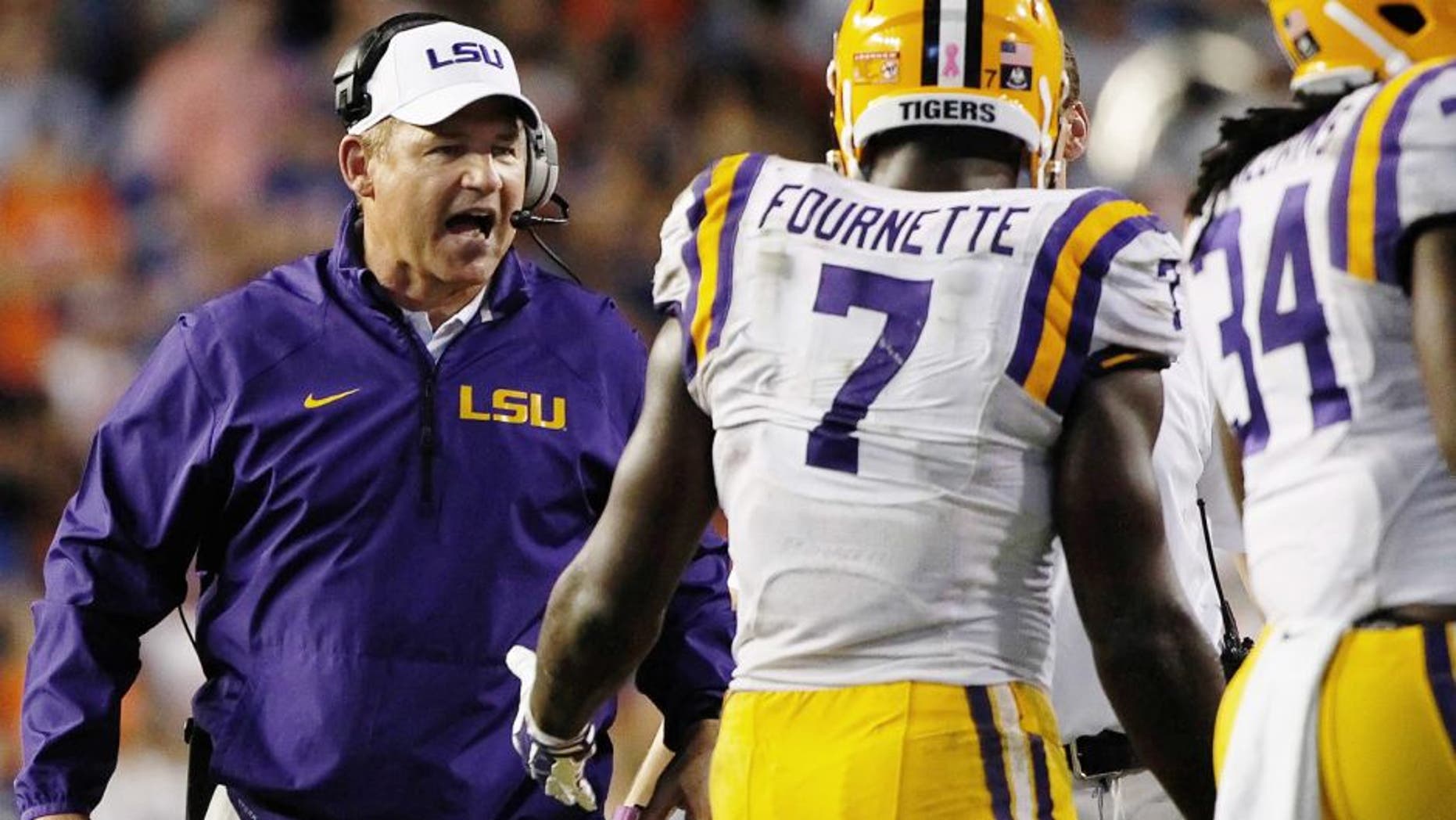 Oct 11, 2014; Gainesville, FL, USA; LSU Tigers head coach Les Miles congratulates running back Leonard Fournette (7) after he scored a touchdown against the Florida Gators during the second half at Ben Hill Griffin Stadium. LSU Tigers defeated the Florida Gators 30-27. Mandatory Credit: Kim Klement-USA TODAY Sports