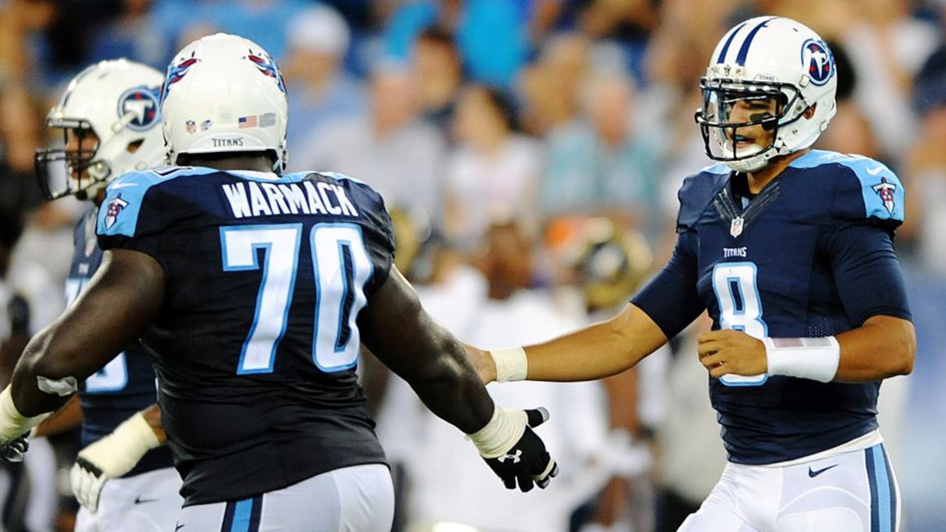 Aug 23, 2015; Nashville, TN, USA; Tennessee Titans quarterback Marcus Mariota (8) is congratulated by guard Chance Warmack (70) after completing a first down during the first half against the St. Louis Rams at Nissan Stadium. Mandatory Credit: Christopher Hanewinckel-USA TODAY Sports