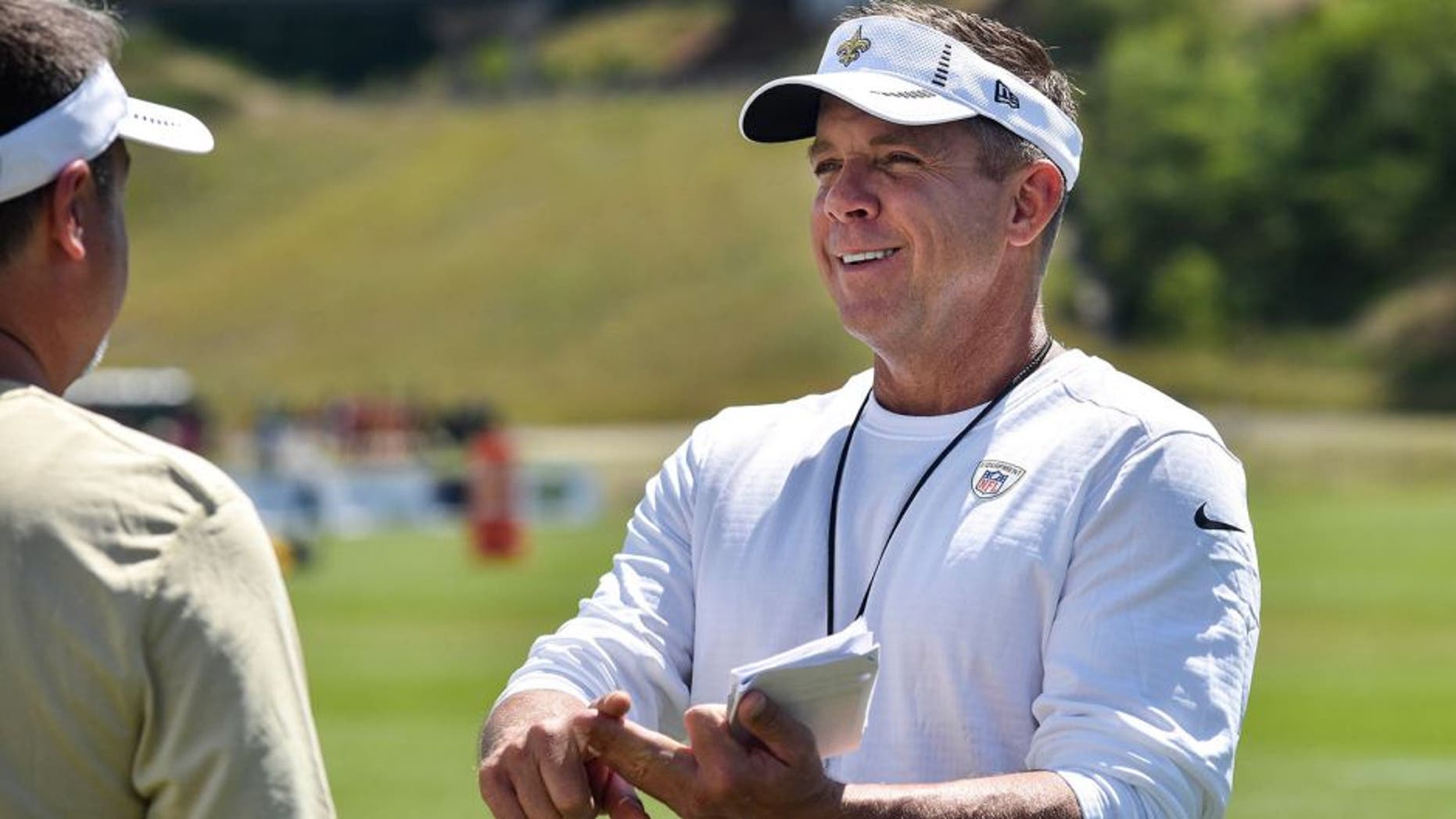 Aug 3, 2015; White Sulphur Springs, WV, USA; New Orleans Saints head coach Sean Payton speaks with a member of his staff following a day of training camp at The Greenbrier. Mandatory Credit: Michael Shroyer-USA TODAY Sports