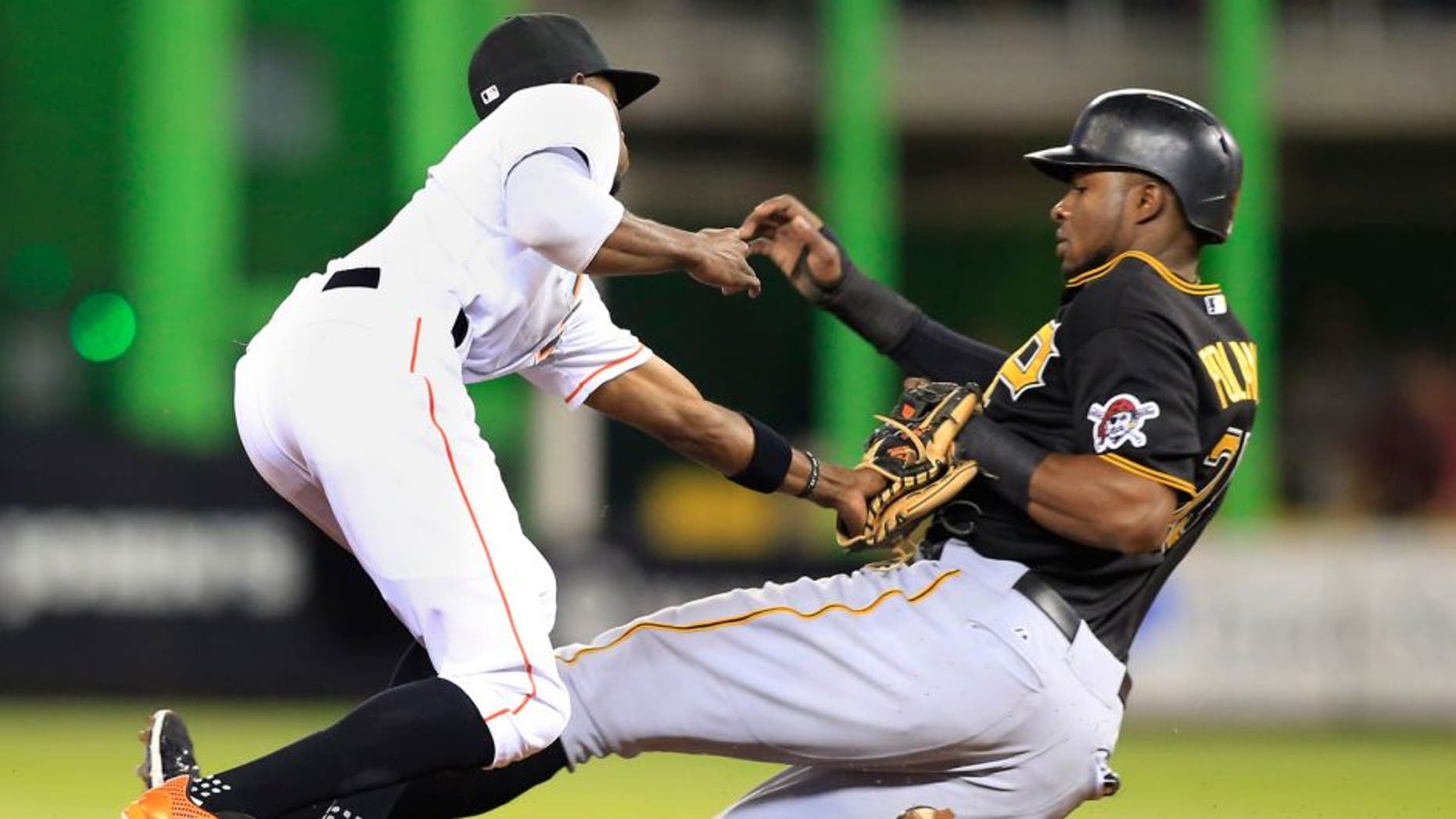 Aug 27, 2015; Miami, FL, USA; Pittsburgh Pirates right fielder Gregory Polanco (25) is out stealing as Miami Marlins second baseman Dee Gordon (9) makes the tag in the first inning at Marlins Park. Mandatory Credit: Robert Mayer-USA TODAY Sports