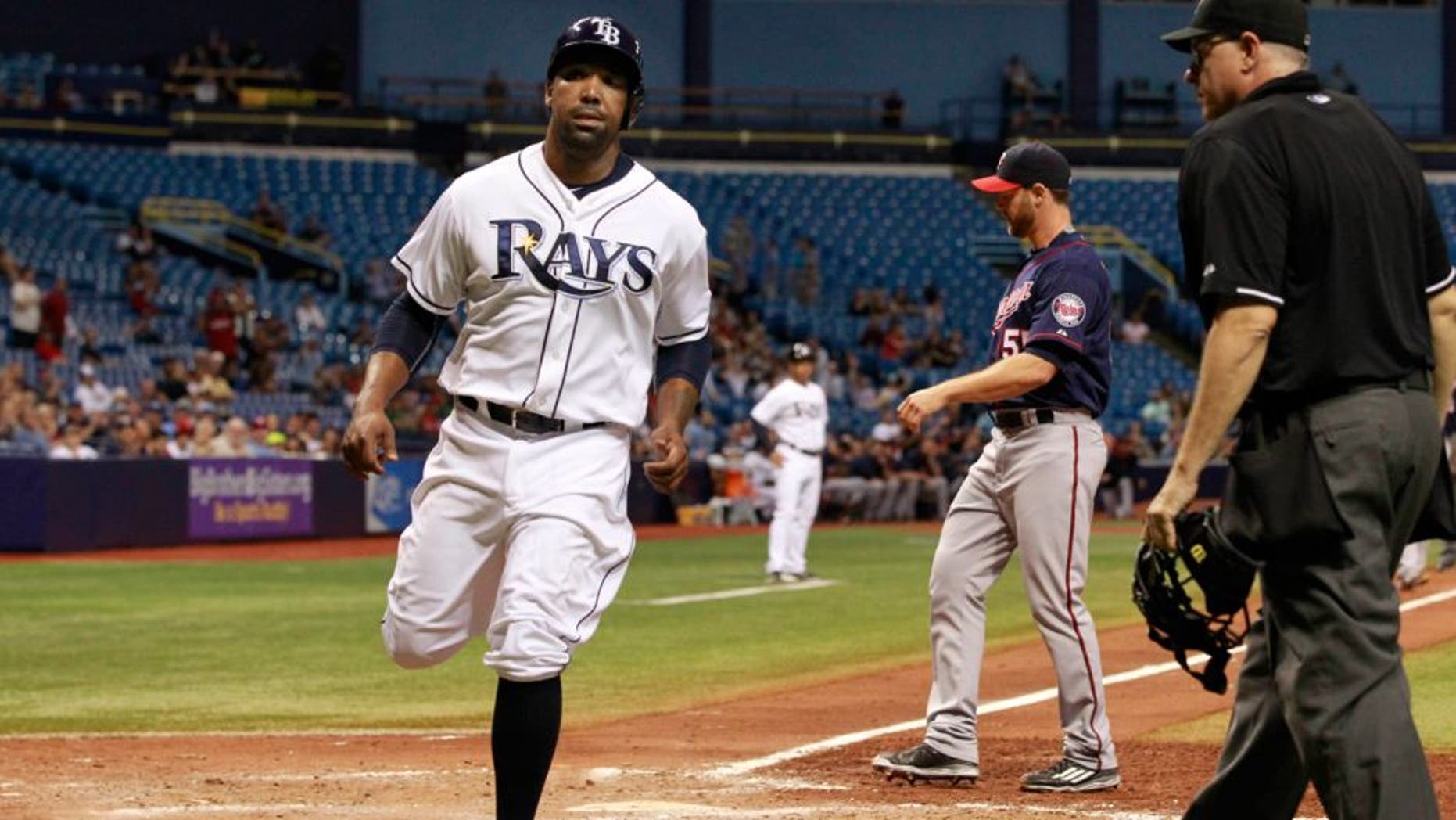 Aug 27, 2015; St. Petersburg, FL, USA; Tampa Bay Rays designated hitter Joey Butler (9) scores a run on a wild pitch by Minnesota Twins relief pitcher Neal Cotts (55) during the sixth inning at Tropicana Field. Mandatory Credit: Kim Klement-USA TODAY Sports
