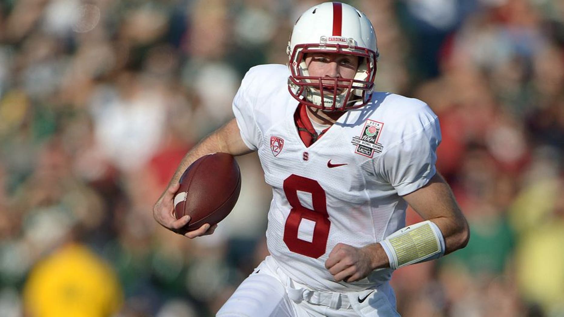 Jan 1, 2014; Pasadena, CA, USA; Stanford Cardinal quarterback Kevin Hogan (8) carries the ball against the Michigan State Spartans in the 100th Rose Bowl. Mandatory Credit: Kirby Lee-USA TODAY Sports