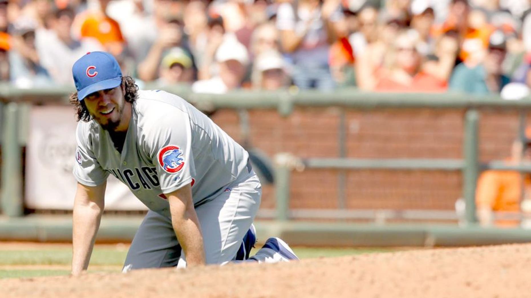 Aug 27, 2015; San Francisco, CA, USA; Chicago Cubs pitcher Dan Haren (50) kneels on the ground after fielding an infield single against the San Francisco Giants in the fourth inning at AT&T Park. The Giants defeated the Cubs 9-1. Mandatory Credit: Cary Edmondson-USA TODAY Sports